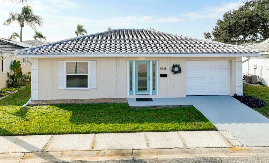 This light and bright 2 bedroom, 2 bath home has been beautifully remodeled with new porcelain tile 
throughout, new kitchen cabinets, stainless appliances, fixtures and bathrooms. When entering, you are welcomed with a spacious living room. Past the dining area, through the french doors you enter the cozy Florida room overlooking a cute patio where you can enjoy sipping your morning coffee or a quiet evening with friends. Down a private hallway, past the large closets is a sizable primary suite with a private en-suite bathroom and access to the Florida room. Bring your clothes, this home is turnkey, absolutely move-ready. The community amenities include a clubhouse, heated pool, library, auditorium, game room w/pool tables & bingo, shuffleboard & workout room with updated equipment and the HOA fee includes cable, internet, building exterior and lawn mowing, water, sewer and trash pick-up. Conveniently located near shopping, restaurants, entertainment and recreations and just a short drive to I-275, airports, St Petersburg, Tampa, and beautiful gulf beaches.