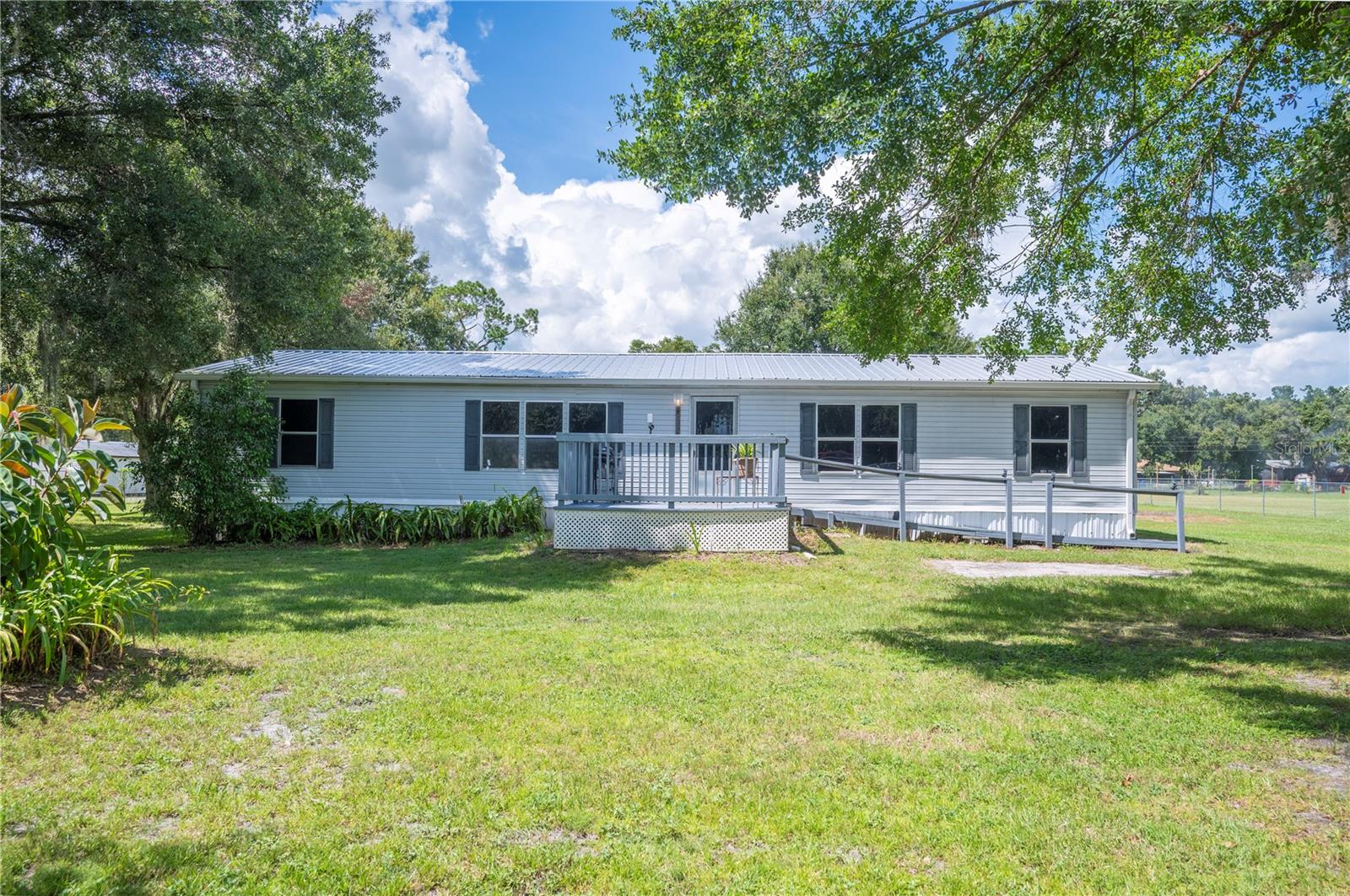 This is a beautiful piece of property on 1.23 acres completely fenced! This is a 4 bed, 2 bath with open kitchen, dining, and large gathering room. Divided bedrooms inside and 1512 sq ft living. Newer metal roof, AC, hot water heater. Loads of room to roam, and close enough to civilization that you don't feel isolated. Text, call, to see immediately. **Agents please see Realtor Remarks.