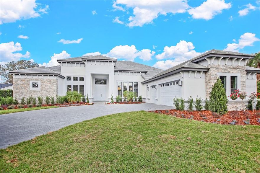 NEW CONSTRUCTION  This amazing home is residing on 15th fairway of Bay Hill Golf Course.  
You will love this ONE FLOOR, 4 BEDROOM, 5 BATHROOM home with its open floor plan and its views of the pool and golf course. The grand open floor plan greets you with a massive soaring 14 foot ceilings, oversized French doors, coffered ceilings, and grand details throughout. The dining room has double chandeliers that compliment the decorative navy blue wall.  The gourmet kitchen is a chef's dream, featuring gas stove top and stainless steel appliances, 12 foot center island, and a large hidden pantry. Just off the kitchen, are the breakfast nook and spacious living room with a electric fireplace with custom wall design. The family room has accordion doors leading to the covered lanai with a full summer kitchen and the resort-style swimming pool. The owner’s retreat offers a private sanctuary complete with separate sitting area, relax and unwind in this spacious retreat, and direct access to the spacious pool and lanai. The spa-like primary bath amazes with a luxurious shower, free standing tub, custom walk-in closets with islands, separate linen closet and more storage than you could ever need. You’ll find the master suite is fit for a king. The additional 3 Bedrooms all feature en-suites and walk in closets. Exit the home through the large glass doors on the main level to the exquisite professionally maintained grounds overlooking the oversized pool, lush greenery, and florals while enjoying the sound of laughter from friends and family who have gathered to bask in the splendor of this estate.  This property is loaded with upgrades which includes 14 ft ceilings, porcelain tile plank floors, 7 &3/4" baseboard throughout the home, wide hallways leading from 3 car garage with extra wide driveway. 2 Tankless water heaters, Propane gas for summer kitchen, dryer, water tank and  stove top.  WELCOME HOME!! Room Feature: Linen Closet In Bath (Primary Bedroom).