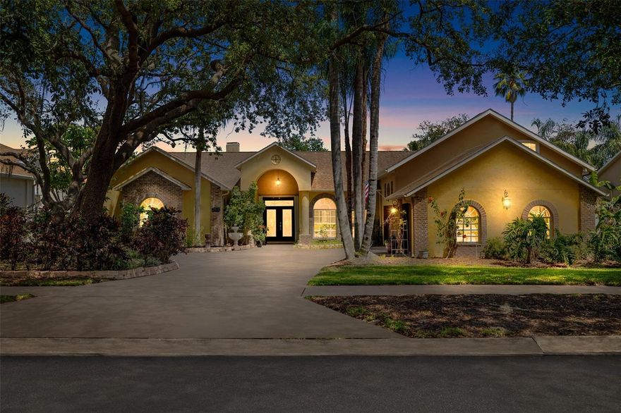 This home is truly a showstopper from the moment you arrive! Set on an oversized lot, with a brick-accented elevation and a side-entry 3-car garage, the curb appeal is just the beginning. You'll appreciate the expansive driveway, arched windows, and beautiful landscaping—all in a desirable, well-established community just minutes from everything this area has to offer.

Step inside and be greeted by soaring ceilings, elegant woodwork accents, and an abundance of natural light. This home features new tile flooring throughout the main living areas. The heart of this home is the newly remodeled kitchen, which is every chef's dream, with modern granite counters, sleek new cabinetry, a center island, walk-in pantry, built-in microwave, convection oven, and a breakfast bar that opens into a cozy breakfast nook. Plus, a wet bar with a sink and wine fridge adds even more convenience and style.

The massive family room is perfect for gatherings, with a wood burning fireplace, built-ins, large windows offering a beautiful view of the pool, and easy access to the kitchen.

The split floor plan provides the ultimate in privacy. The master suite, located on one side of the home, is a peaceful retreat featuring a wood-burning fireplace and a custom-designed walk-in closet with separate his-and-hers sides and a mirrored changing area. The master bath is equally impressive, with a walk-in shower, jetted tub, and dual sinks. Adjacent to the master suite is a versatile office or nursery space.

On the opposite side of the home, you'll find three spacious bedrooms and two well-appointed bathrooms. For added flexibility, there’s a 5th bedroom/bonus or media room upstairs, complete with its own private bath.

The outdoor space is just as spectacular, with a covered lanai featuring an outdoor kitchen with Jenn-Air appliances, fridge, and sink. Enjoy the heated pool and spa with a waterfall feature, the lanai is outfitted with ceiling fans creating the perfect environment for relaxation and entertaining.

This home is truly a rare find—don’t miss out on the opportunity to make it yours!