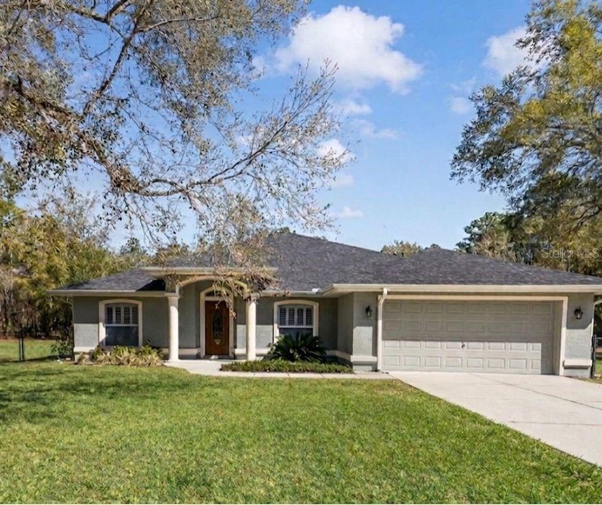 Off-market sale entered for comparable purposes. This well-maintained 4-bedroom, 3-bath home sits on 2.28+ acres and offers a blend of comfort and functionality. Interior features include a spacious layout, crown molding, plantation window shutters, French doors, and a large screened lanai. The kitchen is equipped with stainless steel appliances, quartz countertops, custom wood cabinetry, and a tile backsplash.
The primary suite includes dual sinks, a garden tub, and a glass-enclosed shower. Recent updates include a new roof (2024) and a 16 SEER HVAC system approximately 2 years old, regularly serviced. Exterior highlights include a sprinkler system and an impressive 30x40 workshop with electric, power plug for generator, high ceilings, and two 10x10 doors—ideal for storage, hobbies, or workspace needs.