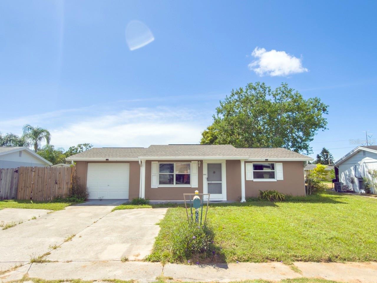 Welcome to this charming 2-bedroom, 1-bath home tucked away in a quiet neighborhood of Holiday. This property is perfect for first-time buyers, downsizers, or investors looking for a low-maintenance Florida lifestyle. Step inside and enjoy peace of mind with major updates already done: Roof (2022), HVAC (2022), double-pane windows for energy efficiency and comfort and updated electrical! The home features a bright, open living space, a functional kitchen, and a cozy dining area. A screened lanai extends your living space outdoors, perfect for relaxing with your morning coffee or entertaining friends. The fenced backyard offers plenty of room to play or garden and includes a shed for extra storage. With no HOA or CDD fees and not located in a flood zone, you’ll enjoy both savings and peace of mind. Conveniently located near shopping, dining, parks, and just a short drive to Florida’s beautiful Gulf beaches. Don’t miss this well maintained gem, schedule your private showing today!