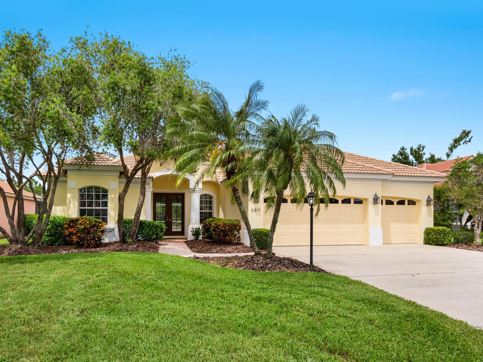 One or more photo(s) has been virtually staged. Lake & Preserve Views with this Spacious Florida-Style Home in Prime Lakewood Ranch Location! Welcome to your own private oasis in Riverwalk Ridge, one of Lakewood Ranch’s original and sought-after neighborhoods, known for its generous lot sizes, A-rated schools, low HOA fees, and central location. Built by renowned builder Lee Wetherington, this charming traditional Florida-style home offers peaceful water and preserve views from nearly every room. Set on an oversized homesite, this beautifully maintained residence features an open-concept floor plan with 3 bedrooms, 3 full bathrooms, two separate living areas, and large private office, perfect for working from home or creative pursuits. At the heart of the home, the kitchen boasts 42-inch cabinets, breakfast bar, closet pantry and a custom alcove with built-in desk and extra storage. The cozy breakfast nook features a built-in bench and a curved aquarium glass window overlooking the screened lanai and sparkling pool, an ideal spot to enjoy your morning coffee while taking in tranquil views of the lake and preserve. The peaceful primary suite is a true retreat, offering an oversized custom walk-in closet and en-suite bathroom with dual vanities, a Roman-style walk-in shower and a soaking tub. Each guest bedroom is located in its own wing of the home, creating private suite-like accommodations for family or visitors. The spacious home office is located at the rear of the home and showcases one of the best views of the home. The lanai area with pool and spa, is perfect for entertaining or relaxing in your own backyard paradise. Recent improvements include newly installed carpet in all bedrooms and fresh neutral interior paint throughout. Ideally located near Lakewood Ranch Main Street, University Parkway, SR 70, top-rated medical facilities, beautiful parks and walking trails and just minutes from UTC Mall. The new Waterside Place Town Center is just a short drive away, offering upscale dining, weekend farmers markets, food truck events and live music. Best of all, you're less than 30 minutes from world-renowned Gulf beaches. Optional membership to Lakewood Ranch Country Club includes access to 4 championship golf courses, 3 clubhouses, 20 lighted tennis courts, 20 pickleball courts, a full fitness center, and an active social calendar. Don’t miss this rare opportunity to own a home with serene nature views and an unbeatable location. Schedule your private tour today!