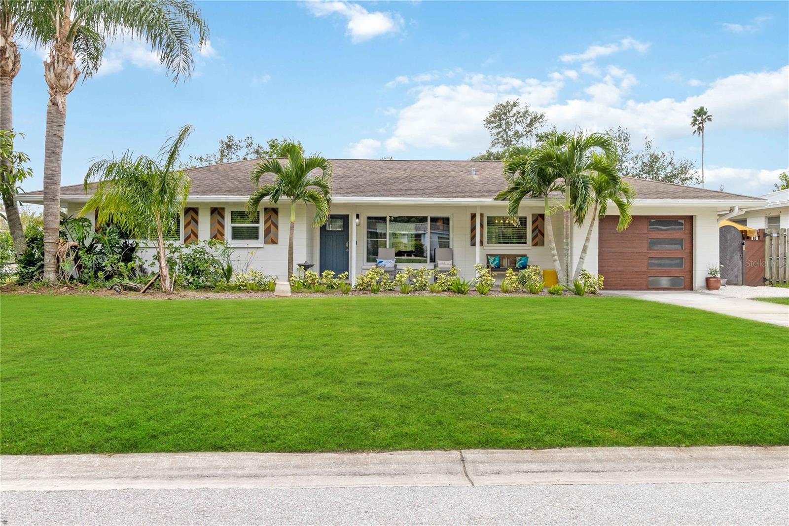 Rarely available! This Southside area home is completely move-in ready and boasts significant updates throughout. Situated on a large, private, fenced lot, offering wonderful outdoor space complete with a heated resort style saltwater pool and patio; perfect for relaxing and entertaining. This 1436 sf home offers two bedrooms, two full bathrooms, a one-car garage, and a separate family room that provides tropical views of the landscaped pool area. The backyard has room for an additional Master Suite or Accessory Dwelling Unit. The updates are extensive and include a new roof, HVAC system, and hurricane-rated doors and windows, including the garage door, ensuring peace of mind. The primary bathroom and kitchen have been beautifully updated with quartz countertops and glass front cabinets, a new range, dishwasher, and water heater. You'll also appreciate the premium vinyl wood plank flooring throughout, the recently painted interior and exterior, new spray foam insulation, new PEX plumbing to all fixtures, and professional outdoor drainage. The 10x14 air-conditioned laundry room and additional flex/office space is a bonus feature not to miss. For those seeking an investment opportunity, this home has a proven short-term rental history when the owner was not in town. Turnkey furnished is a possibility. It's located in the highly desirable heart of Sarasota, offering an easy drive to Siesta Key Beach, biking on The Legacy Trail, Arlington Park, and Downtown Sarasota's countless restaurants and Main Street stores. Best of all, there are no CDD or HOA fees.