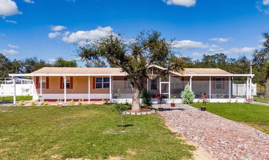 Don’t miss this opportunity to own a beautifully updated double-wide manufactured home situated on over an acre of land in Lake Wales. Now featuring a brand-new roof and a new A/C unit, this spacious home is truly move-in ready.
Inside, you’ll find a generously sized master bedroom complete with a walk-in closet and a private en suite bathroom with dual sinks. The home also offers five additional bedrooms—each with its own closet—and three full bathrooms, making it perfect for large families or those in need of extra space.
The kitchen has been renovated, and new modern flooring runs throughout the home. Fresh interior paint enhances the bright, welcoming atmosphere. A premium under-sink reverse osmosis water filtration system by Osmo Central Water Quality ensures clean, great-tasting water right from the tap.
Additional features include an indoor laundry area with extra storage space for added convenience. Outside, the property offers ample parking with a six-car carport, plus an additional single-car carport. Two storage sheds provide plenty of room for tools, equipment, or workshop space.
This unique property boasts an impressive variety of mature fruit and medicinal trees, as well as vibrant ornamental plants. You’ll find multiple varieties of mango, avocado, guava, pineapple, papaya, green lemon (lime), orange, cherry, star fruit, dragon fruit, melon, and cassava (yuca). It also includes gandules (pigeon peas) and yautía.
For herbs and medicinal plants, the property features oregano brujo, several types of mint, recao (culantro), scallions, sweet peppers, ginger, and aloe vera (sábila).
The lush landscaping is enhanced by beautiful flowers and trees such as hibiscus, beach roses (, orchids, and a stunning yellow flamboyant 

There are also 5 yellow Guayacán trees and 12 pink Guayacán trees, adding vibrant color and shade throughout the property.

The property includes a 6,000-foot irrigation system with 22 water sprinklers, ensuring all vegetation remains healthy and lush.

Additional features include a  5-ton air conditioning unit, a propane tank, potable water well, and much more.