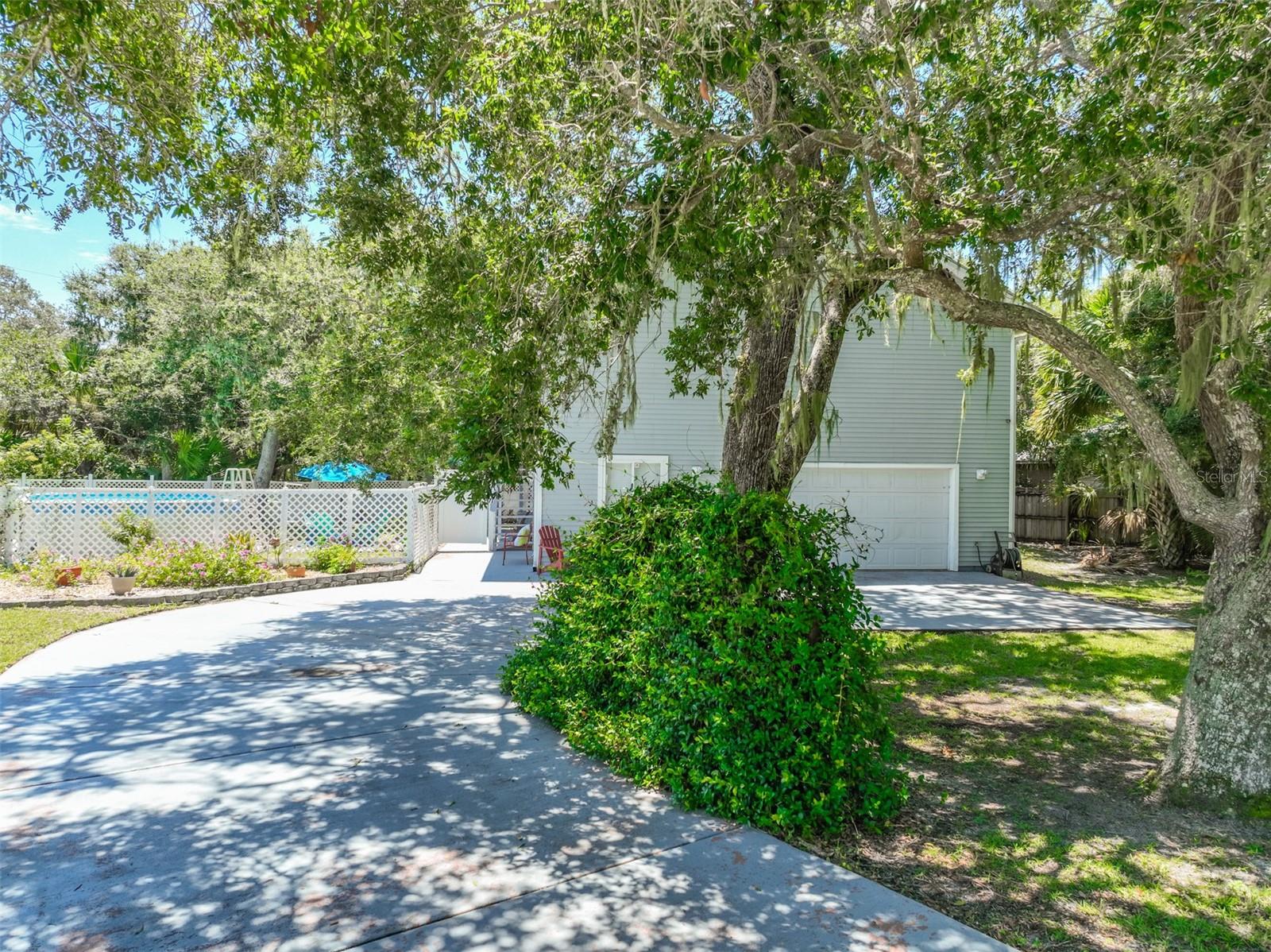 Discover your own private paradise in this coastal home located near Marineland in the Maritime Estates community. It is conveniently located between Palm Coast and St. Augustine. Home has access to the beautiful sandy beach with a dune walkover for private entry. There is also a deeded access to the Intracoastal Waterway at the end of the street with a beautiful covered dock so you can enjoy fishing and peaceful meditation. Both are a short distance from home. You can watch the sun rise on one side and the sun set on the other. This two story home features two master suites, one upstairs as well as downstairs. There is an inside spiral staircase or you can easily install an elevator. The downstairs suite could be used as an in-law suite as it features a living room, bathroom and bedroom with a private access to the garage and sliding glass doors to a rear porch that overlooks the oasis of majestic oaks in the back yard. The upstairs features an open concept with gorgeous wood floors, sliding glass doors to the large screened lanai overlooking the majestic oaks in the back yard and lots of windows to maximize your breathtaking views. Kitchen features a center island bar for entertaining and granite counter tops. This fantastic side yard comes with your own 18 x 36 above-ground freshwater pool, perfect for creating lasting memories with family and friends. Completely fenced in for privacy. Home features include real wood floors, wood doors and trim, a security system and ring doorbell. Water is provided by the city of palm coast and the sewer is a privately owned company and is not part of the water bill. Hot water heater was replaced in 2024 and a/c is approximately 5 years old. The garage is oversized and can fit two cars. It also features an area that can be used for a workshop or craft room. The possibilities are endless. What are you waiting for? Call now to schedule a showing on this beachside paradise!