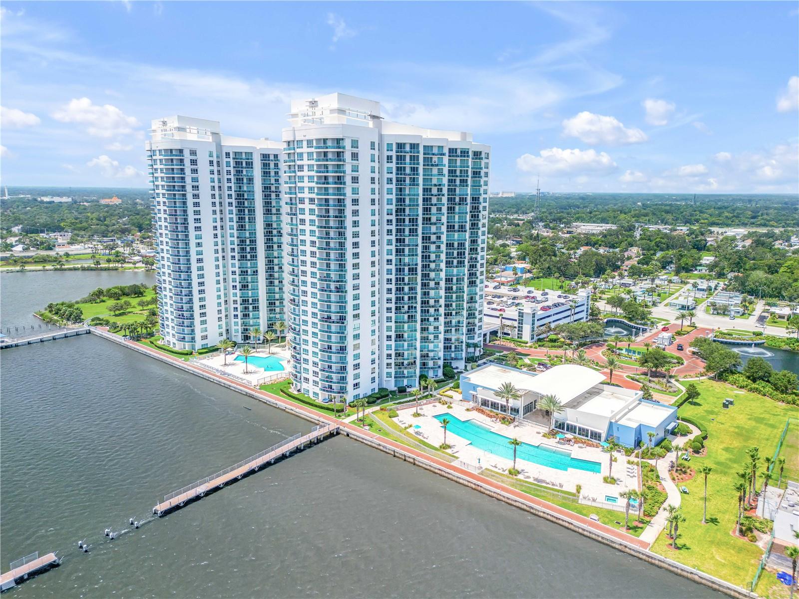 Experience effortless coastal living in Marina Grande unit 2002—a beautifully furnished, move-in ready retreat in one of Daytona Beach’s most desirable waterfront communities. Perfectly positioned near the Seabreeze Bridge, this spacious residence places you just minutes from the Riverfront Esplanade, boutique shops, local dining, and the Atlantic shoreline. Sweeping views of the Intracoastal Waterway and the ocean create an ever-changing backdrop both inside and out. Recent updates include wide-plank luxury vinyl flooring, quartz countertops, shaker cabinetry, a custom kitchen island, and GE stainless steel appliances. The smart split-bedroom layout showcases 9-foot ceilings, generous walk-in closets, fresh paint, custom window treatments, and stylish, comfortable furnishings. Step onto the expansive balcony to watch boats drift by, spot dolphins at play, or greet the sunrise over the water. Marina Grande residents enjoy an array of resort-style amenities—two waterfront pools (including an infinity-edge pool), a whirlpool spa, dual clubhouses, a state-of-the-art fitness center, steam rooms, a private theater, billiards, and event spaces—all secured within 24-hour gated grounds spanning 18 lush acres. Pet-friendly and brimming with upscale features, this residence offers a vibrant coastal lifestyle ready to be enjoyed from day one.