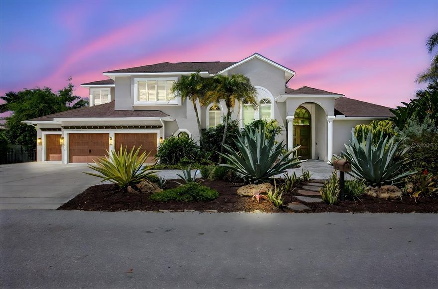 Welcome to refined coastal living in one of Northwest Bradenton’s most coveted waterfront enclaves. Gracefully positioned along the serene waters of McLewis Bayou, this impeccably reimagined estate offers direct access to the Manatee River and the Gulf of Mexico—an exceptional setting. From the moment of arrival, the home makes a striking impression with its grand custom entry, adorned by a richly detailed wood ceiling and timeless architectural finishes. Inside, a curated palette of tumbled travertine marble and warm, hand-selected wood flooring flows seamlessly throughout the main level, featuring plantation shutters, an in-law suite and custom built-ins. Designed for both grand entertaining and intimate living, the residence unfolds with a sophisticated formal living salon that opens gracefully to an expansive terrace and resort-style poolscape. The private dock and boat lift provide immediate access to open water, inviting spontaneous sunset cruises and days spent on the Gulf. The family room is equally captivating, featuring dramatic coffered ceilings, a statement stone fireplace, and a fully appointed wet bar—effortlessly connecting to a sunlit breakfast alcove and a truly exceptional Kitchen The chef’s kitchen is appointed with professional-grade appliances including Sub-Zero refrigeration, Wolf double ovens and a Wolf six-burner gas range, and Miele dishwasher. Custom-crafted cabinetry, polished granite surfaces, a generous prep island with sink, and an integrated dining table create a space that is as functional as it is beautiful. The first level also offers an elegant formal dining room, along with a versatile office or in-law suite and an additional ensuite bedroom Ascending the statement staircase, the private quarters reveal a tranquil primary suite retreat, enhanced by custom cabinetry and a serene ambiance. Two additional oversized bedrooms complete the upper level, sharing a thoughtfully curated bath. Outdoors, the estate transforms into a private waterfront sanctuary. a built-in fire feature, completely redone pool with integrated spa all overlooking the quiet, shimmering bayou.