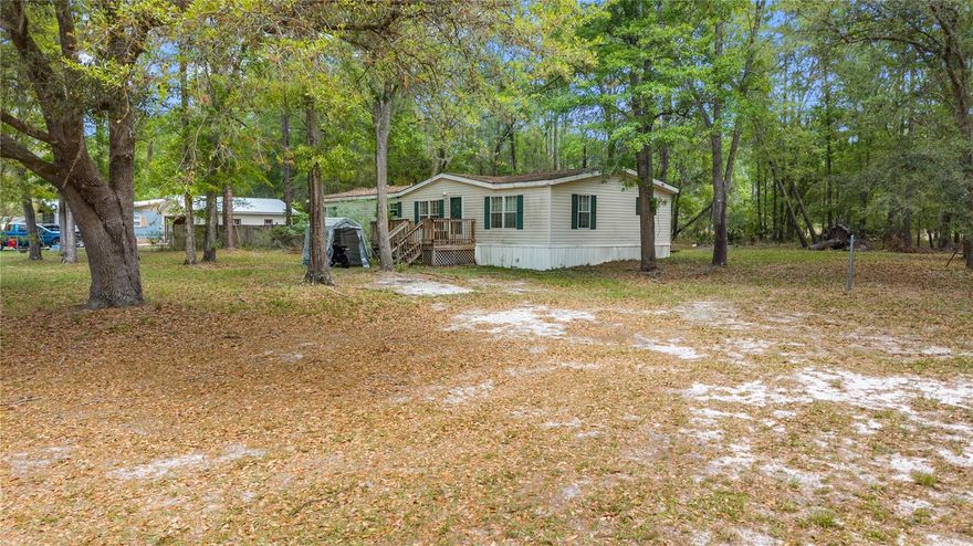 Great potential for this spacious 3/2 doublewide manufactured home on 1 acre of land. Enjoy the peace and privacy right outside of city limits but close enough Gainesville for all the city amenities. Newer HVAC, large kitchen with plenty of cabinet space, large living room with fireplace, vaulted ceilings. Don't miss the primary bedroom with garden tub and walk-in closets. Front outdoor space includes productive blueberry bushes—an attractive, sustainable addition for future homeowners.