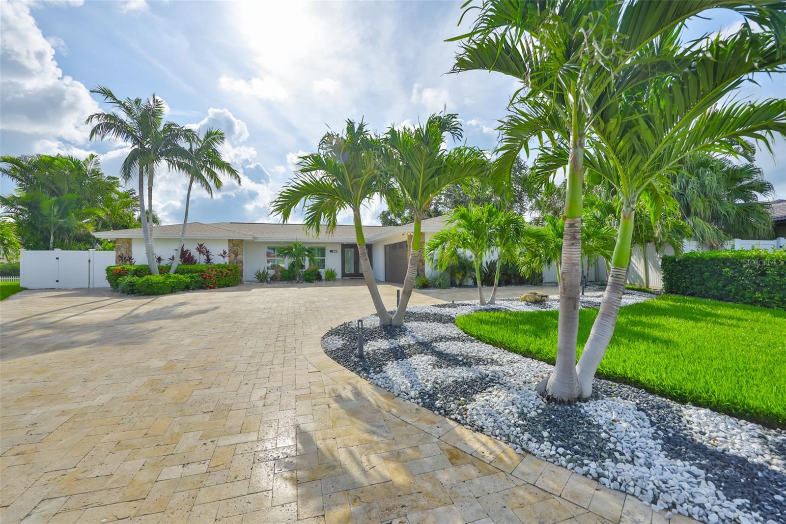 Welcome home to this small piece of paradise located in the desirable Harbor Bluffs! This waterfront 3 bed, 4 bath, 2 car garage single-family home is situated in the majestic Harbor Bluffs subdivision. Prepare to be enchanted by the open-water views that greet you upon entering this beautiful residence. Just minutes away from the renowned Clearwater Beach, this stunning property promises an unparalleled lifestyle of luxury & comfort. Featuring 3 bedrooms & 4 bathrooms, each thoughtfully designed to offer both privacy & convenience, each bedroom has its own private entrance to the outside, providing privacy from the other bedrooms. One bedroom can also be used as an office, offering the perfect space for remote work with a stunning view of dolphins playing in the water. At the heart of the home lies an extraordinarily open floor plan, anchored by a true chef's kitchen equipped with a Viking double oven, stove, & dishwasher. The oversized kitchen has an abundance of storage & counter space, including a wine & coffee bar with granite countertops, all providing a beautiful flow as you look out over the water while preparing your favorite meal. The back of the house features three large sliding windows that invite the beauty of the outdoors in. The property is equipped with impact-rated exterior doors & a new shingle roof installed in 2024. A new A/C system was also be installed in 2024, along with a room addition completed in 2023, & a new boat dock installed in 2019. For boat enthusiasts, the newly installed dock paired with a 13,500 lbs. boat lift allows for effortless access to the stunning waters of the Gulf. The primary bedroom serves as your personal retreat, with a walk-in closet, his & her sinks, a large tub, & a shower. This home has 2,504 square feet of living space, with a total gross area of 3,371 square feet. The home is fully automated with a Control 4 system throughout, providing speakers outside for an incredible entertaining experience. The outdoor kitchen features a grill, ice maker, mini fridge, & sink, all with granite countertops for amazing outdoor grilling with all the comforts of the indoors. The side yard is a wellness retreat, beautifully landscaped with a sauna & outdoor shower. Here you can relax & enjoy a morning yoga session & feel rejuvenated by the outdoor shower in the open air with nature, offering a tremendous amount of privacy. The backyard features a beautiful pool with waterfall features overlooking the water, professionally landscaped to capture the beauty of the home itself & provide a private retreat. The two-car garage caters to your vehicle & storage needs, with newly epoxy floors & a split unit to keep the inside of your garage cool. Notably, this property is one of the higher elevated properties on the road. The home's exquisite design flows beautifully & effortlessly, providing amazing views from each room. With Belleair Bluffs - charming shops & restaurants just a short walk away, & the vibrant communities of Clearwater & St. Petersburg a quick drive, you'll enjoy an array of dining & entertainment options at your leisure. Golf enthusiasts will revel in the proximity to three world-class golf courses designed by the legendary Donald Ross, all within five minutes away. This meticulously maintained slice of paradise is not just a house; it's a lifestyle waiting for you to embrace. Don't miss your chance to call this remarkable waterfront residence your own. Schedule your private showing today!