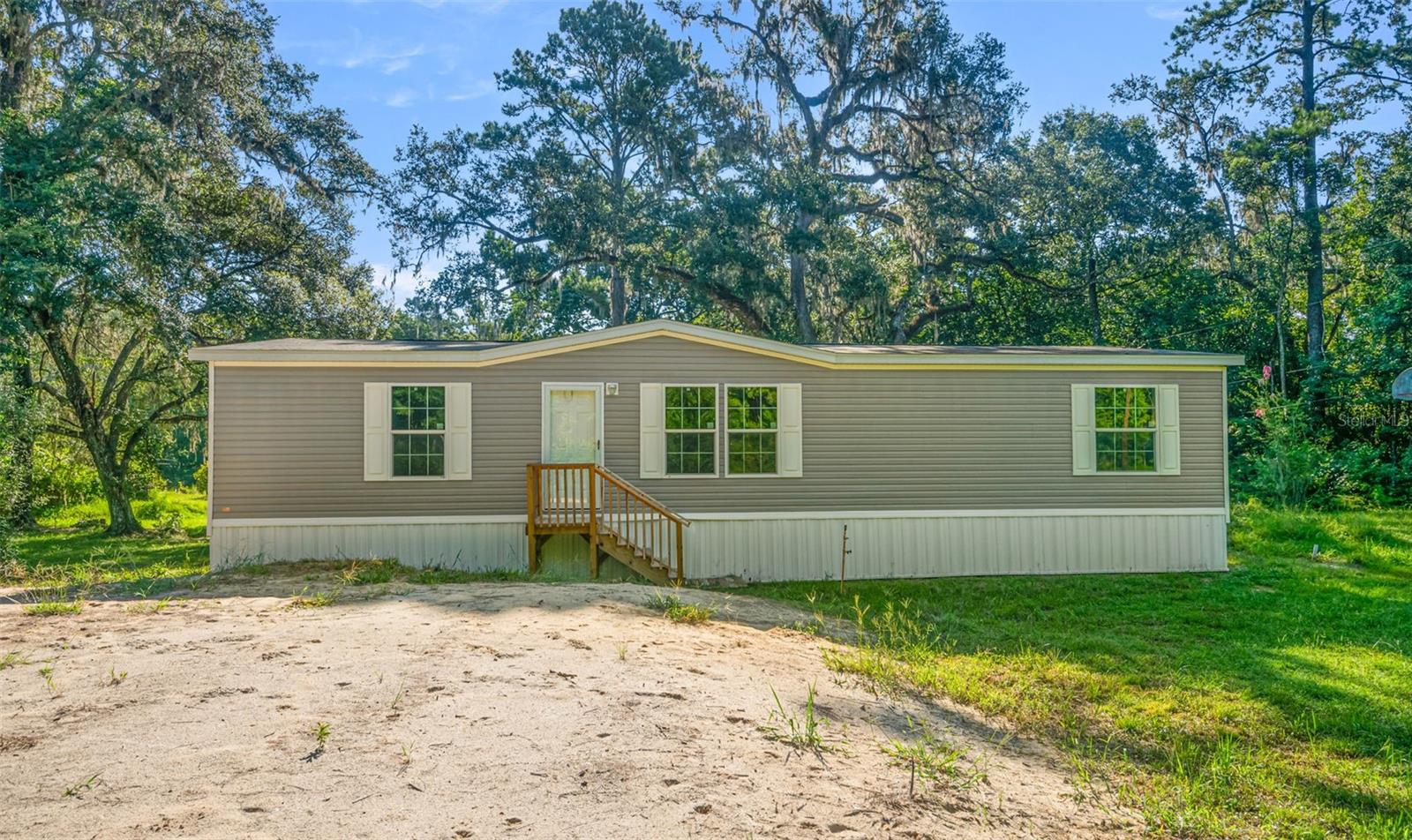 Peaceful Riverfront Living in Nobleton – 4.1 Acres on the Withlacoochee River!
Tucked away in the quiet, close-knit community of Nobleton, this brand-new manufactured home offers peaceful waterfront living on a gorgeous 4.1-acre parcel, with 2.1 acres of buildable high ground and 2 acres remaining with a canal and river frontage. The property is beautifully shaded by mature live oak and hickory trees, creating a natural lifted canopy over a landscape that invites both relaxation and outdoor enjoyment.
A unique highlight is the unfinished grotto, featuring stonework and custom water features—a one-of-a-kind space just waiting for a creative buyer to bring it to life as a private garden sanctuary, meditation space, or outdoor entertaining area.
Located on the banks of the scenic Withlacoochee River, this property is a nature lover’s dream. Just 1,000 feet away, you'll find the Withlacoochee State Trail, ranked #2 in the United States for biking and walking, and the Withlacoochee State Forest, offering endless opportunities for hiking, birdwatching, hunting and outdoor adventure.
Despite its secluded feel, you're conveniently located just minutes from downtown Brooksville, Floral City, and Bushnell. Interstate 75 is only 10 minutes away, making commuting simple or getting to the airports and other area attractions, while preserving the peaceful atmosphere of small-town living.
Whether you’re looking for a permanent home, a weekend retreat, or a nature-infused investment, this rare riverfront gem offers the perfect balance of seclusion, accessibility, and potential.
So many opportunities on this property await you!