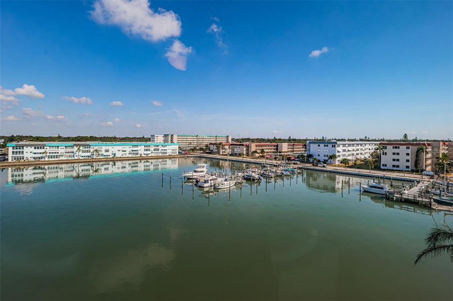 Step inside and let the view steal the show. The moment you open the door, your gaze glides through the open kitchen and living space to the shimmering water of Boca Ciega Bay — a calm sweep of blue where dolphins play, manatees drift by, and the marina gently hums with coastal life. From this 5th-floor vantage point, every day brings a new watercolor sky: soft sunrises, glowing sunsets, and the surprise of a rainbow arching across the bay after a passing shower.

The northern exposure keeps the home cool and comfortable even in the height of summer, while hurricane-rated windows frame the scenes outside like living art. The layout, refreshed a few years ago, enhances the sense of openness. Rich mahogany-toned tile stretches warmly underfoot, ceiling fans keep the air moving, and several freshly painted walls and ceilings bring a clean, uplifting feel. From the dining table, the water becomes your backdrop — glistening, peaceful, and endlessly soothing.

Practical comforts blend seamlessly with the beauty. Laundry and storage are just steps from your door. Gas, water, Internet, and pest control are included in the HOA, and fees are locked through 2026 — remaining lower than several other Town Shores buildings. Thanks to the northern light and efficient construction, the electric bill stays remarkably low.

Town Shores offers the kind of 55+ waterfront lifestyle people dream about: multiple pools tucked throughout the community, tennis and pickleball courts, landscaped paths perfect for evening strolls, serene seating along the seawall, and a marina with renovated docks and a kayak launch — a front-row seat to the wildlife that calls this bay home.

And just beyond the community, Gulfport shines with its artsy, eclectic spirit — a vibrant waterfront town full of galleries, beloved restaurants, the Tuesday Morning Market, live music, and year-round events that make this place feel alive and welcoming.

This Lancaster residence offers space, serenity, and a view that greets you like a familiar melody — a Gulfport treasure where life slows down, the water sparkles, and the best parts of Florida unfold right outside your window.