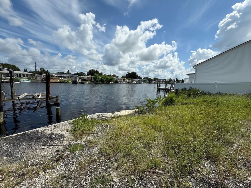 **OWNER FINANCING AVAILABLE WITH QUALIFIED DOWN PAYMENT** Discover the perfect opportunity to build your dream waterfront home on this vacant canal-front lot. Featuring a sturdy seawall already in place, this property offers peace of mind and easy access for future dock or boat lift installation. With direct water frontage, you’ll enjoy scenic views, relaxing breezes, and the chance to design a residence tailored to your lifestyle. Whether you envision a weekend retreat or a year-round home, this lot provides a strong foundation for your vision. Conveniently located near shopping, dining, and area attractions, while still offering a serene waterfront setting, this is a rare chance to create your own piece of paradise. Additional lot at 5251 Boardwalk is also available.