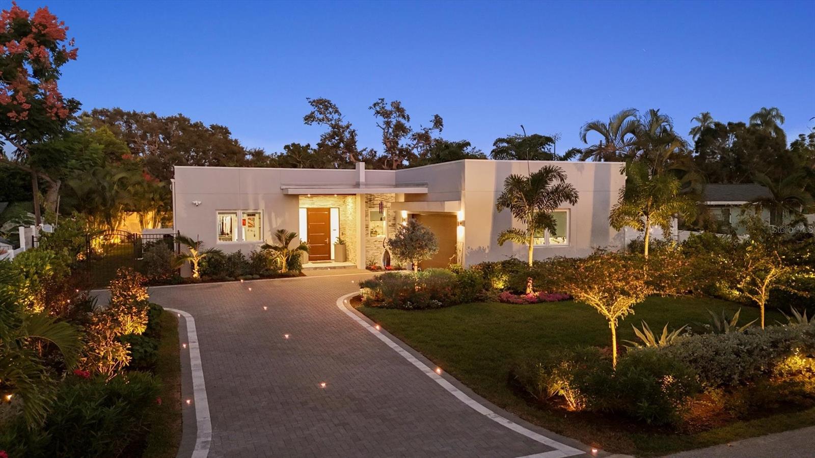 SMART, SOPHISTICATED, STUNNING ~ YOUR CUSTOM SARASOTA OASIS AWAITS!  Experience modern elegance and luxury living in this exceptional custom-built home with a resort-style pool in one of Sarasota’s most sought-after neighborhoods near Southside Elementary. Designed with impeccable attention to detail, this stunning residence showcases high-end finishes, luxury, technology, and thoughtful design with no stone left unturned. The open-concept Great Room, Kitchen, and Dining Area seamlessly extend to the covered lanai with an Outdoor Kitchen complete with grill, cooktop, fridge, sink, & storage, and Resort-Style Pentair Saltwater Pool with Built-in Hot Tub and Color Changing Lights —perfect for entertaining or relaxing in your private oasis. This home's elegant kitchen is equipped with a large island offering ample seating and Reverse Osmosis water purification, while a large Laundry Room/Mudroom/Pantry off the kitchen adds convenience and functionality. The Great Room features an electric fireplace with heat, and abundant space to accommodate a large dining table or additional seating.  The luxurious Primary Suite offers a spa-like retreat with custom walk-in closet, dual sink vanity, multiple shower heads, a Kohler smart self-cleaning toilet with bidet, and expansive sliding glass doors that open directly to the secluded pool and lanai for effortless indoor-outdoor living. Built with Solid Construction and Impact-Rated Windows and Doors, this home is equipped with a Maintenance-Free Whole House Halo Water Treatment System, Smart Appliances (refrigerator, washer, dryer), Smart Thermostat, Security System with Exterior Cameras, new Solar Inverters with SolarEdge System, and Blue Light Purification in the A/C for modern comfort and efficiency. Additional upgrades include: an Air-Conditioned Garage with EV Charging Station and Epoxy-Fleck Flooring, New Paver Driveway with Inset Lighting, New Irrigation and New Lush Landscaping, New Vinyl Privacy Fencing with a Beautiful Wrought-Iron Gate, Custom Designer Lighting, and $60,000 in New Porcelain Tile Flooring Throughout the Home. Just minutes to Southside Village, Siesta Key, Downtown Sarasota, St. Armands Circle, Lido Key, and walking distance to Southside Elementary, this home offers the ultimate Sarasota lifestyle in one of the area's most desired locations, close to Sarasota Memorial Hospital, shopping, dining, award winning beaches, arts & entertainment.  CLICK THE VIRTUAL VIDEO TOUR LINK TO SEE DAYTIME, NIGHTTIME, & A BIRD'S EYE VIEW OF THIS EXQUISITE, OUTSTANDING PROPERTY.