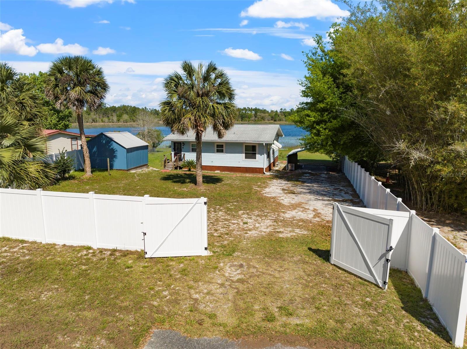 WATERFRONT/ MOVE IN READY HOME ON OVER A QUARTER OF AN ACRE. Private double gated entrance. Fence installed 2023. Updated kitchen & bathroom w/ deep soaker tub in 2022. 30yr architectural shingle roof 2017. Heat pump installed 2020 & updated windows throughout. Enjoy sunrise/sunset from your private dock rebuilt in 2023, or relax on your solid back deck built in 2021. High speed internet available. Fully owned Culligan High Efficiency water softener/filtration system provides excellent quality water. Downtown Crescent City grocery stores, shopping, and restaurants nearby. Various beaches within a short drive. Second largest lake in FL Lake George & Crescent Lake, w/ free boat launches, just minutes away. This property is a MUST VIEW! Have your offer ready.