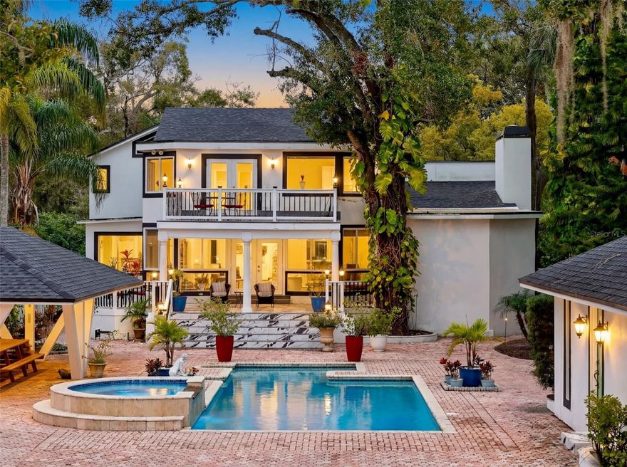 This riverfront retreat is more than a home, it’s a lifestyle. Nestled along the peaceful Hillsborough River, this stunning 3-bedroom, 3-bath residence offers direct access to Tampa Bay and the Gulf, making it easy to hop on your boat and cruise to dinner, downtown shows, or sandy beaches. The moment you arrive, the fully pavered circular drive welcomes you with elegance, and the beauty only grows from there. The backyard is a true oasis: a sparkling, recently resurfaced pool and spa surrounded by lush landscaping, a large covered cabana with dining space for entertaining, and a detached air-conditioned pool house with its own full bathroom for guests or a private retreat. The dock, designed without underwater poles, was built for durability and stunning views, making sunsets here unforgettable. Inside, the home is full of charm and thoughtful upgrades. The spacious kitchen, dining area, and family rooms all overlook the river, while the primary suite, which is nearly 700 sq ft, features its own balcony for the best views in the house. A full wine room lets you store and savor hundreds of bottles in style. With one bedroom and full bath on the first floor, this layout is ideal for guests or multi-gen living. The home has newer stucco, a 3-year-old roof, a 4-year-old AC, and appliances that are all under four years old. Freshly updated lighting front and back creates the perfect evening ambiance. Just minutes from Armature Works, Riverwalk, Hyde Park, downtown, the airport, and Tampa’s best dining, this is the rare riverfront gem that truly offers it all—style, privacy, location, and peace of mind.