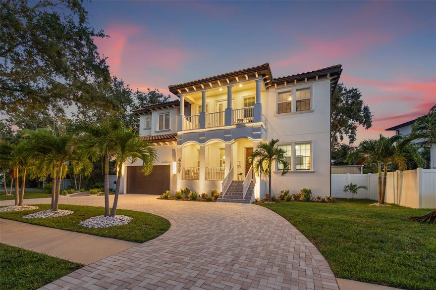 Welcome to Snell Isle, one of the area’s most sought-after Luxury enclaves, where elegance, functionality, and innovation converge. This custom-built beauty by Mobley Homes offers an exceptional opportunity to own a 7-bedroom, 4.5-bath masterpiece spanning 4,401 square feet of thoughtfully designed curated living space. From its elevated construction to its designer finishes, this home delivers the ultimate in Luxury living—with no HOA restrictions and electric bills as low as $35/month, thanks to premium solar energy efficiency. As you arrive, a brick-paved circular driveway & manicured tropical landscaping set the tone for what lies beyond. Step inside to discover porcelain and ceramic tile flooring, a grand foyer, and a formal dining room with an accent wall that immediately captures attention. Coffered ceilings, custom gold and brass lighting, and hurricane-impact windows reflect the home's uncompromising quality and elevated style. The heart of the home is the gourmet kitchen, perfectly outfitted for the discerning chef. Enjoy Quartz countertops, a Monogram gas cooktop with 6 burners, built in microwave/speed oven, Bosch dishwasher, Monogram refrigerator, and a dry bar with soft-close drawers throughout. The expansive center island includes hidden storage, built-in spice drawers, and additional seating for entertaining and casual meals. A charming breakfast nook featuring a shiplap accent wall offers a relaxed place to start the day. Just off the kitchen, a walk-in pantry, mud area, and smart layout provide seamless functionality. Designed for both grand entertaining and quiet retreat, the main level features a study/den with custom glass French-style doors—ideal as a home office or an additional bedroom. A guest suite with a private ensuite bath provides visitors with privacy and comfort. A main-level pool bath adds convenience for outdoor entertaining, and the home is prewired for surround sound throughout for immersive media experiences. Step outside to your resort-style backyard featuring a saltwater pool with new pump, a covered patio area, vinyl fencing, irrigation system with 8 zones, and an integrated French drain turf system—all surrounded by lush new palm trees and enhanced by landscape lighting and mosquito misters for year-round enjoyment. Additionally there is an open patio space with access to build out a custom kitchen & grill area. Upstairs, the primary retreat is a sanctuary of its own. Enjoy the luxurious ensuite with a large walk-in shower, dual sink vanity, and an expansive custom walk-in closet with built-in shelving and storage. Additional upper-level bedrooms include Jack & Jill bathrooms, a private balcony, generous walk-in closets, and smart layout design for family or guests. The home is elevated 10 feet, offering both peace of mind and architectural presence. Systems include 2 HVAC units, a tankless gas water heater, and a 250-gallon propane tank that powers the stove and water systems. An EV-ready garage features a Stage 2 charger, while the smart thermostat, security system with Ring doorbell, 3 outdoor cameras, and Vivint home integration provide next-level comfort and protection. With no HOA and superior upgrades & finishes throughout, this is more than a home—it’s a statement. Just minutes away from the cultural pulse of Downtown St. Pete, this property delivers a vibrant lifestyle. Enjoy proximity to Vinoy Park, the Tampa Bay waterfront, award-winning schools, restaurants and speciality dining.