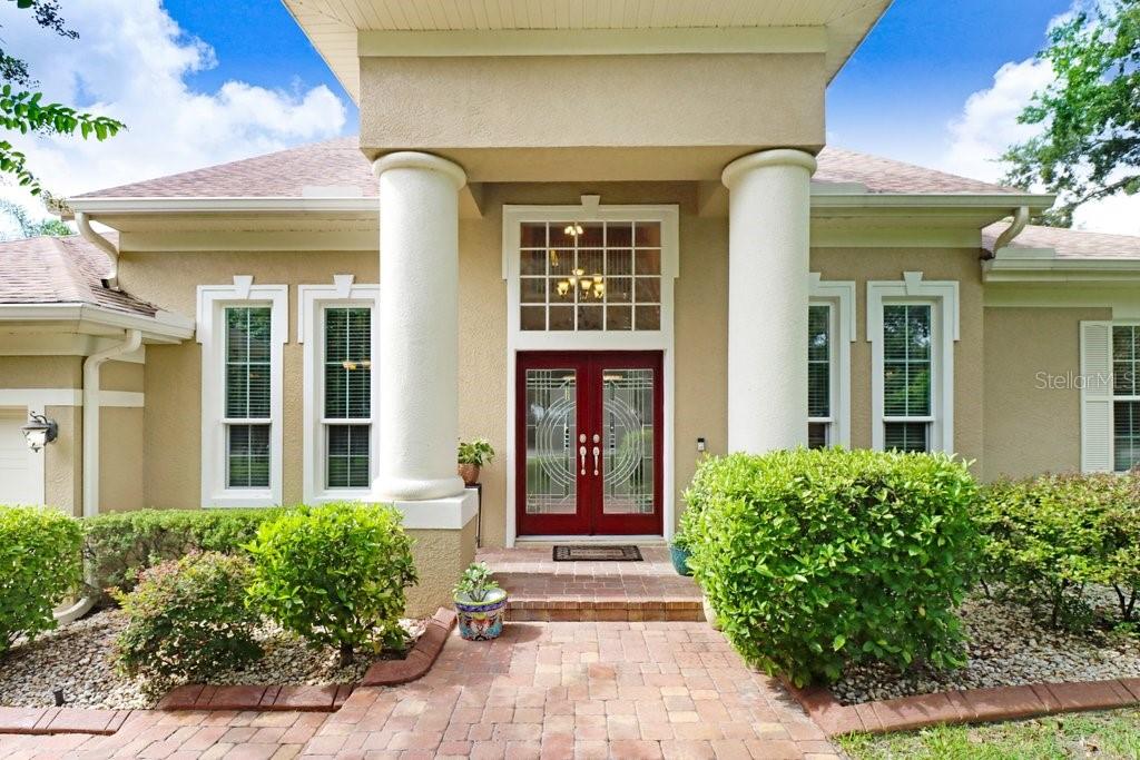 Welcome to your private oasis in the heart of the highly sought-after Fox Run community! Nestled on an expansive .65-acre homesite, this stunning 4-bedroom, 3-bathroom estate with a 3-car garage offers space, privacy, and refined comfort in one of Lutz’s most desirable neighborhoods. A beautiful tree-lined driveway welcomes you home, leading to elegant French doors that open into a grand foyer with soaring ceilings, architectural columns, and crown molding throughout the formal living and dining rooms perfect for entertaining in style. The sprawling first floor features a thoughtfully designed open layout, combining a spacious family room and a gourmet kitchen complete with wood cabinetry, granite countertops, custom backsplash, and a walk-in pantry cooled with A/C. You’ll love the slide-out drawers and abundant storage, plus a breakfast nook overlooking the screened saltwater pool and pavered lanai. The owner’s suite is a true sanctuary with ample space, and a luxurious master bath featuring a sound system and steam shower for ultimate relaxation. A first-floor guest bedroom with adjacent full bath provides comfort and privacy for visitors or multi-generational living. Upstairs, you’ll find two generously sized bedrooms, a full bath, and a versatile bonus room ideal for a home office, media room, or playroom. Step outside to your park-like fenced backyard, surrounded by manicured hedges, mature trees, and flowering landscaping offering peace, privacy, and space to unwind. This home checks every box for those seeking comfort, luxury, and space with room to grow, entertain, and relax. Conveniently located near top-rated schools, shopping, and dining, this is the lifestyle you’ve been waiting for. Schedule your private showing today and experience the magic of Fox Run living!