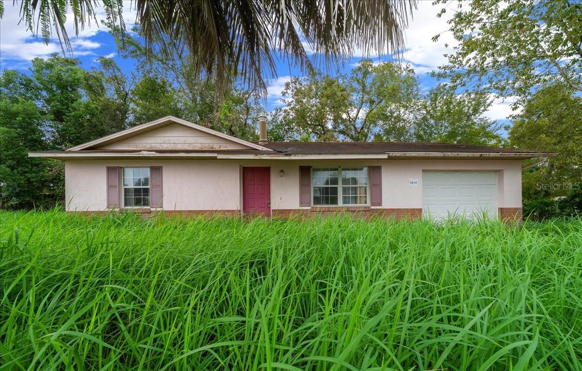 There is no power. Investor special. This two-bedroom, one-bath single-family home is located on a paved, publicly maintained road in the Florida Heights subdivision, conveniently near Ocala and The Villages. Built in 1983, the home offers 840 heated square feet on a cleared 0.23-acre lot. Constructed with concrete block and finished in brick and stucco, it sits on a slab foundation and features a shingle roof. Zoned R1 within a single-family residential neighborhood, the property is not in a flood plain and has no HOA fees or age restrictions. Utilities include public water and a septic tank, with electricity available but currently disconnected. Interior features include a living room and dining room combo, a freestanding wood-burning fireplace, carpet and linoleum flooring, and dual closets in both bedrooms. The home also includes a one-car attached garage with assigned parking. Offered as-is and priced to reflect its current condition, the property requires extensive renovations and improvements throughout. It presents an excellent opportunity for investors or buyers seeking a value-add project with strong equity potential. This could become a great rental income property. Schedule a showing or consultation to explore the possibilities.