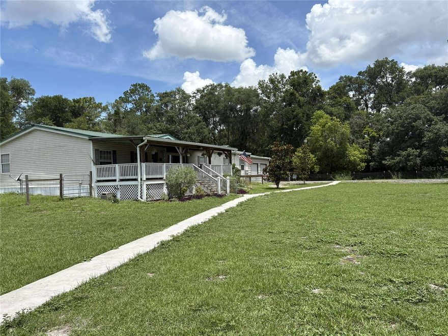 3.5 ACRE 5 BR 2 BATH  2008 2000 SQ FT MANUFACTURED HOME BY FLEETWOOD, WITH FIRE PLACE, ON CONCRETE FOUNDATION , metal roof,WHOLE HOUSE GENERATOR,  X LARGE square kayak pool with wrap around composite deck, covered front and rear decks, rain gutters, 1 attached 2 car garage 1 un attached 2 car garage, new in 2025 central heat and AC system, RV carport, several out buildings , large fire pit , music stage, covered out door grilling area ,several out buildings storage sheds , personal rv hook ups , entertainers dream property, on private property, secluded yet close to beaches , natural springs , airports , country living at its best , bring horses, boats, motorcycles, toys , ready for whatever your into.