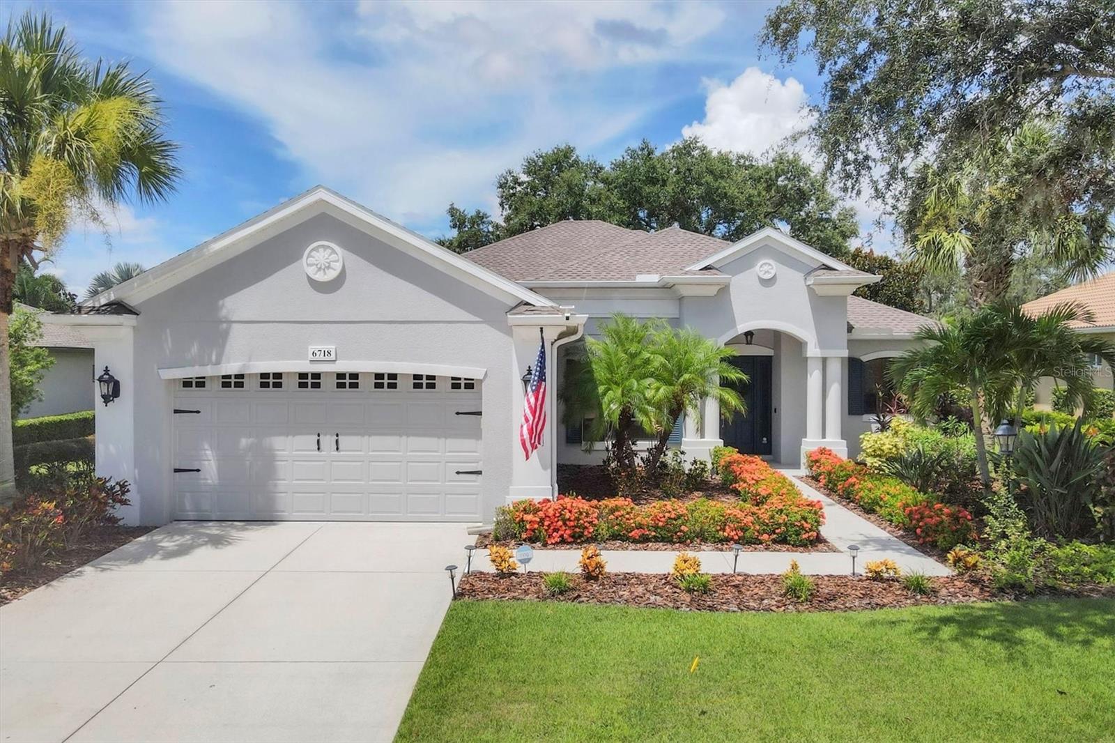 Location, location, location! This beautifully updated home in The Ravines of Greenbrook Village sits on one of the most desirable homesites in the community, framed by a magnificent oak tree and overlooking a peaceful lake. A sparkling private pool invites you to relax and entertain—now with a brand-new pump (2025).
The curb appeal is undeniable, with landscaping that has been thoughtfully and lovingly enhanced, creating a warm welcome before you even step inside. Once indoors, you’re greeted by a bright, open great room with soaring ceilings and sliding glass doors to the lanai. The formal dining room flows seamlessly into the open kitchen and dining nook, now showcasing a complete style update: new backsplash, redesigned island, freshly painted cabinets, and new hardware—paired perfectly with a new oven and range hood (2024) and a charming built-in breakfast bench.
The bathrooms have been tastefully reimagined with modern finishes and design details that feel fresh yet timeless. All-new hardware, ceiling fans, plumbing fixtures, and light fixtures enhance the home’s cohesive, updated look.
Comfort and convenience are elevated by smart home features that control the stereo, lighting, fans, security system, sprinklers, and a smart thermostat allowing you to manage heating and cooling from anywhere. A newly built entertainment center adds both style and function.
Four generous bedrooms with luxury vinyl flooring and built-in closet systems offer ample space, with bedroom 4 including its own custom built-in closet—perfect for guests or family. Practical upgrades abound: a striking new roof (2024) that delivers peace of mind for years to come, tankless water heater (2022), HVAC (2023), newer refrigerator, washer, and dryer, and a Level 2 EV charger in the garage.
For qualified buyers, a VA assumable loan offers a unique financing opportunity.
Located in the heart of Lakewood Ranch, you’ll enjoy access to top-rated schools, parks, shopping, and healthcare. Explore walking trails, dog parks, fishing ponds, golf courses, and nearby sports facilities. With easy access to I-75, Sarasota’s cultural attractions and the pristine Gulf beaches are just minutes away.
Experience the best of Florida living—modern updates, an unbeatable location, and move-in ready comfort await you in this exceptional home.