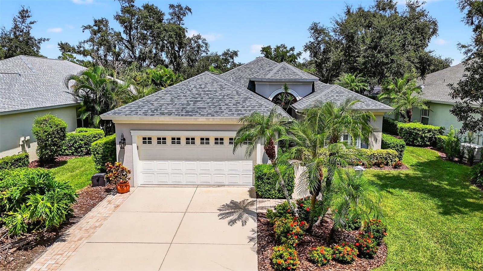 One or more photo(s) has been virtually staged. This 4-bedroom, 2-bath home in Harborage on the Braden River has been updated from top to bottom and is ready for its next chapter. From the moment you arrive, the paver walkway and inviting front entry set the tone for a home that’s both stylish and comfortable.
Inside, the open floor plan is filled with natural light and anchored by a dramatic floor-to-ceiling stone electric fireplace. The matching stone detail in the built-in dry bar with bar fridge and wall niche ties the space together beautifully. Barn doors and pocket doors add character and function, offering a way to separate guest bedrooms from the main living area.
The kitchen, fully renovated in 2023, features quartz countertops, gold hardware and faucets, under-cabinet lighting, and subtle shiplap touches that carry throughout the home. There’s room for casual meals in the eat-in kitchen as well as a separate formal dining room for gatherings.
The primary suite is generously sized, bright, and offers an en-suite bath with gold-trim finishes. When it’s time to relax or entertain, the pocketing sliders open fully to connect the indoors with the screened lanai and an extended paver patio—large enough for hosting and surrounded by tall privacy shrubs for a peaceful setting.
Recent upgrades include a new roof in 2021, HVAC in 2023, water heater in 2016, and a new garage door opener in 2022. The washer and dryer, purchased in 2022, are also included with the home.
Harborage offers more than just a home—it’s a lifestyle. Residents enjoy a marina with boat docks, walking trails, fishing pier, canoe and kayak launch, heated pool and spa, clubhouse, fitness center, and gated entry. Conveniently located near shopping, dining, and major roadways, this home blends thoughtful updates with everyday comfort and is well worth seeing in person.