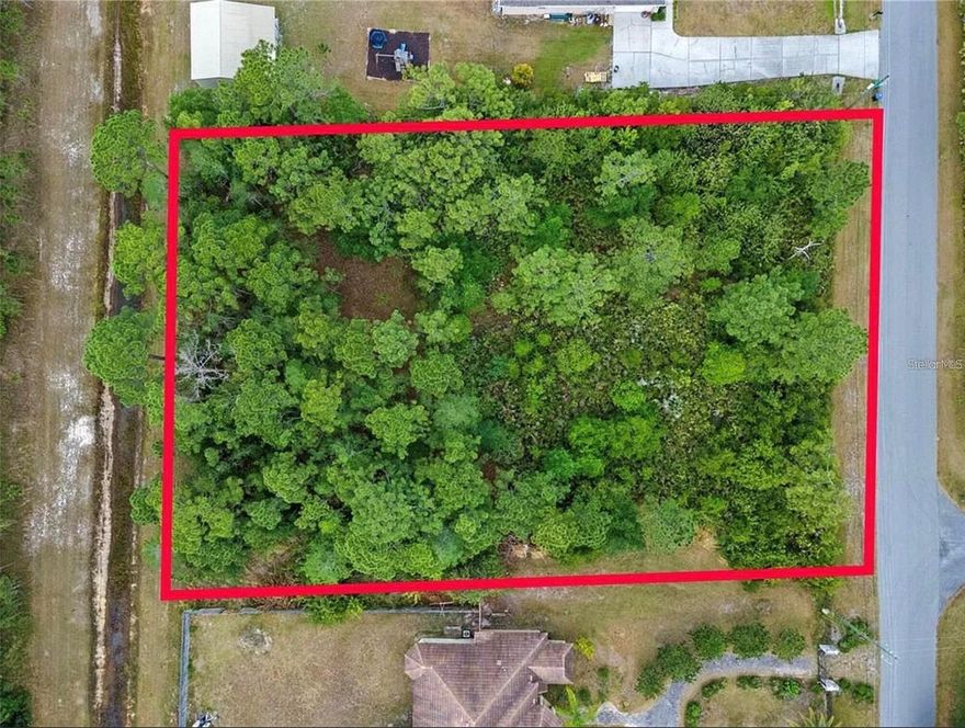 Private 1.24-acre homesite in the desirable Wedgefield area of Orlando featuring 180 feet of frontage and approximately 300 feet of depth. This oversized lot backs up to a natural creek buffer, offering added privacy with no direct rear neighbors and plenty of room to build your custom dream home, workshop, detached garage, or outdoor living space. Located in a quiet estate-style community with well and septic typical for the area, while still being conveniently close to Orlando International Airport, Lake Nona, UCF, and major roadways. Large homesites with this kind of privacy and space are becoming harder to find in East Orlando, making this a great opportunity to build now or hold as an investment. Buyer to verify all building requirements and utility availability.