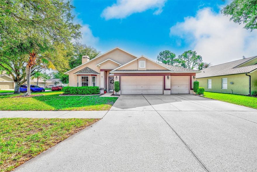 Tucked within the sought-after Twin Lakes community, this spacious 4-bedroom pool home sits on a desirable corner lot surrounded by mature landscaping and the natural beauty the neighborhood is known for. With its scenic lakes, towering oak trees, and expansive park spaces, Twin Lakes offers a setting that feels peaceful while still being conveniently located.

This home delivers the features buyers are looking for, including a newer roof (2022), A/C system (2023), and a 3-car garage. The fully fenced yard is beautifully maintained with lush green grass, tropical accents, and decorative curbing, creating great curb appeal and a private outdoor setting.

Out back, enjoy your own screened-in lanai and pool area—perfect for relaxing or entertaining year-round. Inside, the layout is both functional and inviting, featuring a spacious great room with a wood-burning fireplace and an open eat-in kitchen complete with stainless steel appliances, center island, pantry, and Corian countertops. Hardwood and tile flooring run throughout the home, offering a clean, low-maintenance living environment with no carpet.

Additional details like crown molding, custom trim work, and honeycomb window treatments add character and style throughout. The split bedroom floor plan provides privacy, with the primary suite set apart and offering direct access to the lanai, a custom walk-in closet, and a spacious en-suite bath. Three additional bedrooms are well-sized and share a full bath, making the layout ideal for family or guests. A formal dining space with French doors opens to the lanai, seamlessly connecting indoor and outdoor living.

The backyard offers plenty of space to enjoy, whether hosting gatherings or simply unwinding, and includes a smart irrigation system that adjusts based on local weather conditions for efficient lawn care.

Residents of Twin Lakes enjoy access to community amenities including a private pool, tennis and basketball courts, and walking paths around the lakes. The neighborhood’s park and shaded green spaces add to the overall lifestyle, making this a place people truly enjoy calling home.