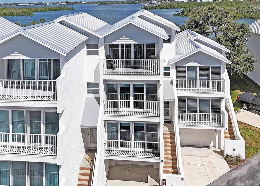 **Sunrise, Sunset, Bay & Gulf Views. Spacious Garage and steps from Englewood Beach**
Rarely available 3-story, 3-bedroom, 3-bath coastal townhome—just across the street from Englewood Beach. The bright and spacious living area unfolds across three levels. Wake up to the sunrise over Lemon Bay and wind down with colorful sunsets over the Gulf from your private balcony in this coastal retreat. 
Meticulously maintained and thoughtfully furnished in a relaxed coastal style, this TURNKEY-FURNISHED home features plank vinyl flooring throughout, (tile in kitchen and baths). Move-in ready with the added benefit of rental potential.
The FIRST FLOOR features a fully equipped kitchen with stainless steel appliances, wood cabinetry, and Corian countertops, opening to a combined living and dining area. Sliding glass doors lead to a balcony with views of Lemon Bay. A versatile bedroom with an adjacent full bathroom includes a built-in Murphy bed—ideal for guests or flexible use.
Reaching the SECOND FLOOR you’ll find a spacious guest suite with crown molding, expansive sliders framing partial beach views, ample closet space and a large private ensuite bath with a wide glass-enclosed shower.
The THIRD-FLOOR primary suite is a welcoming retreat, featuring tray ceilings and expansive impact-resistant sliding glass doors that open to a private balcony with beautiful Gulf views. Designed for comfort and style, the ensuite bath boasts dual vanities,  wood cabinetry, Corian countertops, and a spacious walk-in shower. Sunlight pours in through a wall of windows, and the walk-in closet—with built-in shelving—offers ample storage for your cloths.
ADDITIONAL FEATURES include: Hurricane impact windows and sliders, custom shades on all windows, all rooms have fans, The tandem garage runs the entire length of the home, providing ample space for parking and storage of all the toys. With garage doors at both ends, accessing your outdoor/fishing gear, bikes, or kayaks is simple and convenient.
Live Oak Landings is a small enclave of 23 units on Manasota Key. Residents enjoy exclusive access to boat dockage (first-come basis), a heated pool, and a fishing pier. Here you can embrace the rhythm of island living. Start your day with morning yoga or stroll along the white sandy beach, later sip cocktails at tiki bars with live music, or launch your kayak into nearby waters. Just minutes away, you’ll find Englewood’s vibrant amenities, shopping and the beloved Englewood Farmers Market. Be sure to view the 360 tour for additional local info. Schedule a private tour to see this lovely beach getaway at 2255 N Beach Rd. #9 today!