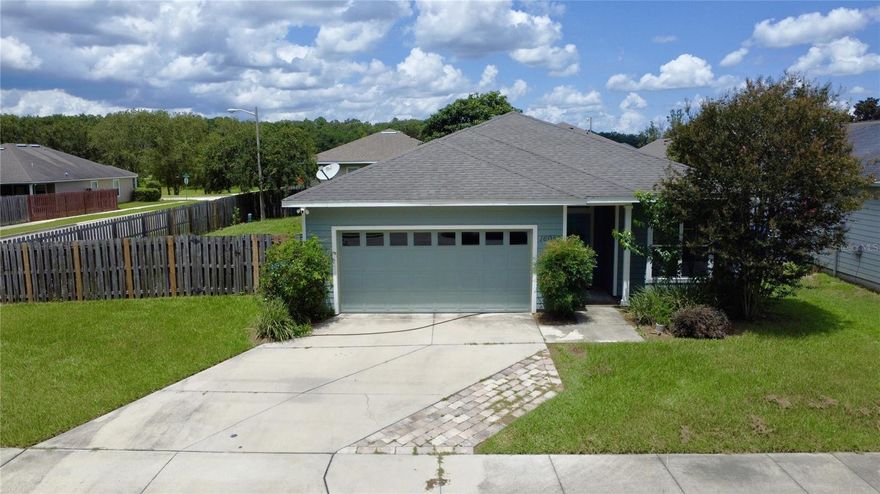 Welcome to this contemporary single-family home located on a premium corner lot in Alachua’s Savannah Station neighborhood that is for sale! Built in 2013, this residence has a smart and inviting layout that features 3 bedrooms & 2 full bathrooms, a split floorplan for both privacy and open-plan entertaining.  There is low maintenance LVP flooring in the main living areas of the home and newer carpet in the bedrooms. The owners’ suite has a walk-in closet and an ensuite bathroom with double vanity and a shower. A newer oversized sink is in the bar of the kitchen, that is at the heart of the home, as well as a pantry for storage and a newer dishwasher & microwave range. The home has an interior laundry room, a double car garage with a newer garage door opener for car parking or to provide storage for your outside tools and toys. The hot water heater was replaced in 2020. The fully fenced corner lot yard is spacious and gives plenty of room for a garden, a child's playset, a firepit and backyard BBQs. The yard also has a fruit-producing Loquat tree as an additional treat! The neighborhood features sidewalks, green space & a community playground. And a bonus -a new community pool is coming to be finished by end of 2025! Located only 5 minutes to downtown Alachua for restaurants and shopping and a short commute to Gainesville and the University of Florida and hospitals, and convenient to I-75 for out of town travels.  For those who enjoy getting outside, here you will be close to world class clear water springs & rivers for diving, swimming & boating as well as state preserves for biking and hiking! Whether this is your first home, your retirement home or an investment property -this is a great North Florida home to invest in! Call today to schedule your private showing!