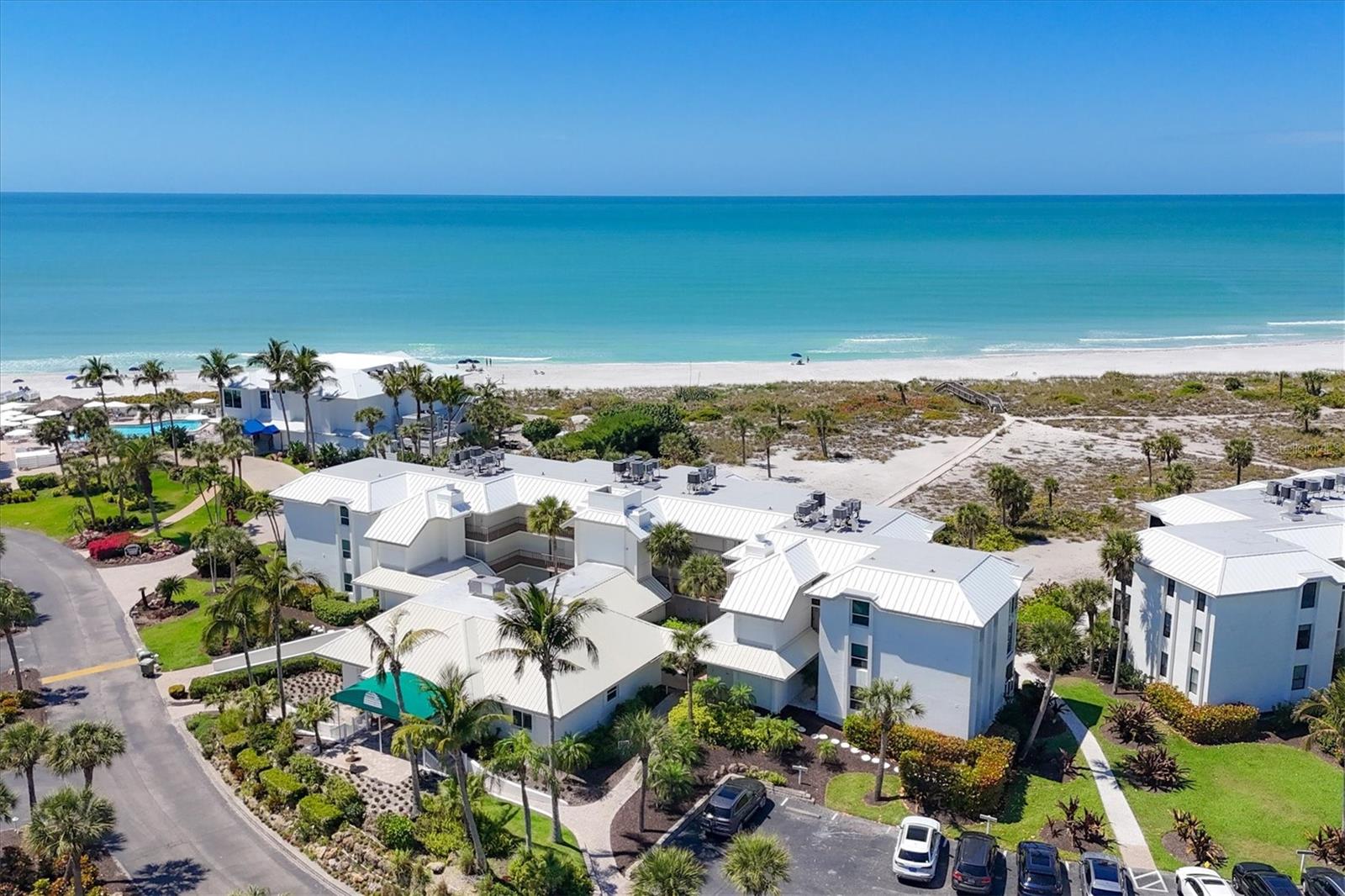 Fantastic new price. Elegantly designed with a comfortable coastal style, this one bedroom, 2 full bath direct Gulf front Dunes Chalet at the Boca Grande Club offers luxury Island living. Beautifully remodeled and handsomely furnished, enjoy spectacular Gulf of Mexico views and sunsets, or use the convenient back door access to easily have your toes in the warm Gulf waters. Sleeps 4 people comfortably with the second full bath, larger living room space, and with the superbly multi-functional and finely crafted credenza that turns into an easily operable Murphy bed with a true queen size bed. The remodel included adding rich wood flooring throughout, impact windows and sliders, glass railing to maximize the views, superb chef's kitchen with quartz counter tops, premium appliances, and tile backsplash. Stunning bathrooms each have tiled showers with heavy glass shower doors, double vanities in the master bath, quartz counter tops, and exceptional plumbing fixtures. The Island property also offers an elevator and stackable laundry. The incredible private gated beachfront community offers some of the most spectacular and secluded beach in Florida. The Boca Grande Club offers elite amenities including a magnificent Gulf front clubhouse with gourmet dining, Gulf front tiki bar, 3 swimming pools, eight clay tennis courts, tremendous fitness facility and activities center. Bicycle or golf cart down the golf cart path to town. Virtually all the tasteful furnishings are negotiable, making this a move-in ready, turnkey opportunity.