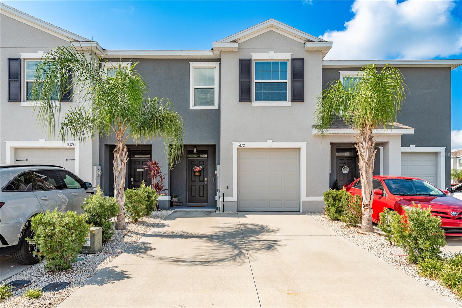 Welcome to this adorable, like-new townhome built in 2021, offering modern farmhouse chic style and worry-free living in the heart of Odessa. This 3-bedroom, 2.5-bathroom home features an open-concept layout with spacious living and dining areas, a convenient half bath, and a charming foyer downstairs. The kitchen is a true standout, boasting stainless steel appliances, espresso wood cabinetry, granite countertops, a subway-tiled backsplash that carries onto the breakfast bar, a stainless farm sink, and a roomy walk-in pantry. Tasteful upgrades throughout include stylish lighting, upgraded fans, and plenty of storage — including a hidden storage area beneath the stairs. Upstairs, you’ll find a generously sized primary suite with en suite bath, two additional bedrooms, and a second full bath. Relax or entertain on the large, screened-in lanai, perfect for grilling or unwinding after a long day. The one-car garage adds extra convenience, and the all-concrete block construction ensures peace of mind — plus, it’s not in a flood zone! Low quarterly HOA fees give you access to a community pool, gym, clubhouse, parks, dog park, basketball and soccer fields, and playgrounds. This move-in ready gem checks every box!