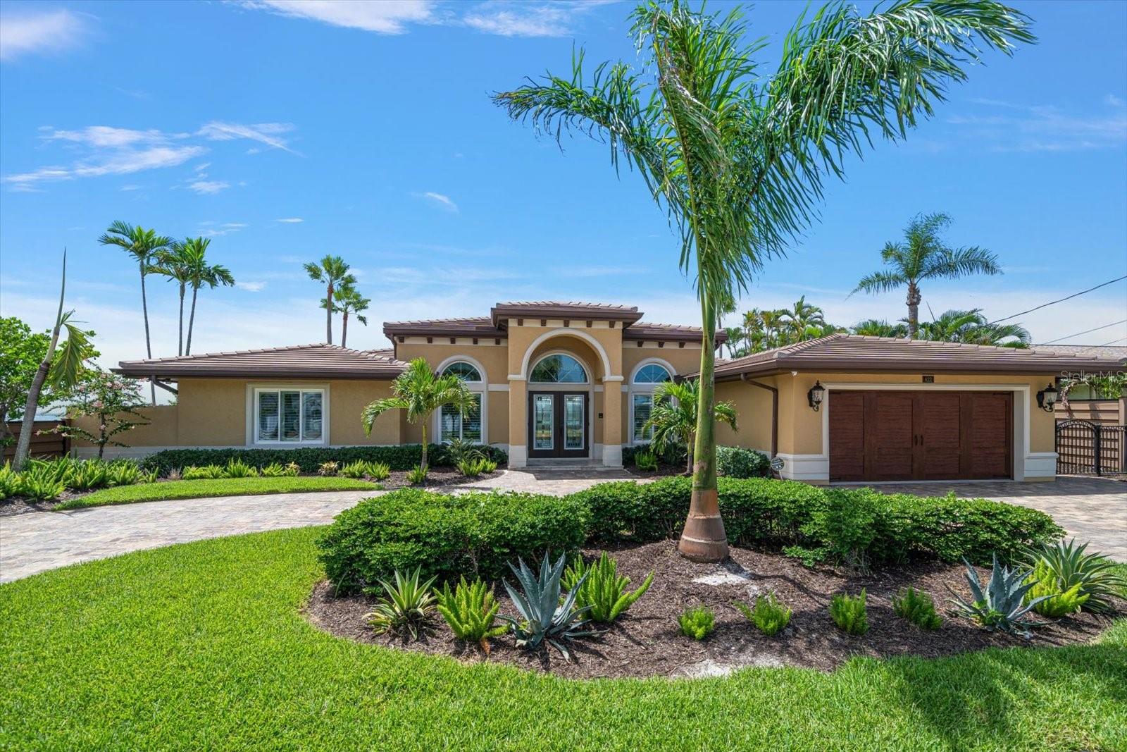 Paradise found on Boca Ciega Bay. Exceptional home located in one of the most desirable neighborhoods in St. Pete Beach. This custom rebuilt home represents a dream fulfilled. Throughout an extensive renovation, the owners carefully thought about every detail in designing the perfect luxury home for their family where all of their needs were met. 5 Bedrooms, 4 bathrooms, approximately 3000 sq. ft. of heated living space all on one level. Expansive & sensible open floor plan with 12 foot soaring ceilings, 10 Foot hurricane rated impact resistant sliding glass doors allow the intoxicating water views of Boca Ciega Bay to enter into their home. Relaxing owner’s retreat. Resort Style Pool & Spa with covered patio & outdoor kitchen. Fireplace, Laundry room, Butler’s pantry & 2 car garage. This home has it all. Located in the heart of St. Pete Beach, close to local dining, entertainment, shopping and one of the most beautiful white sandy beaches along our coastline with easy access to the interstate, Downtown St. Petersburg, the Tampa Airport & more. Please see the full feature sheet as there are too many features to list. It will be difficult to find a more comfortable floor plan.(See floor plan attached) Enjoy the aerial video to gain a true understanding of this breathtaking waterfront location on Boca Ciega Bay, just Steps to the Beach. Although this is a hard house to say goodbye to, the owners are ready to pass this very special home on to the new owners. Are you ready to fulfill your waterfront dream? After viewing the virtual tour, call today for a personal tour.