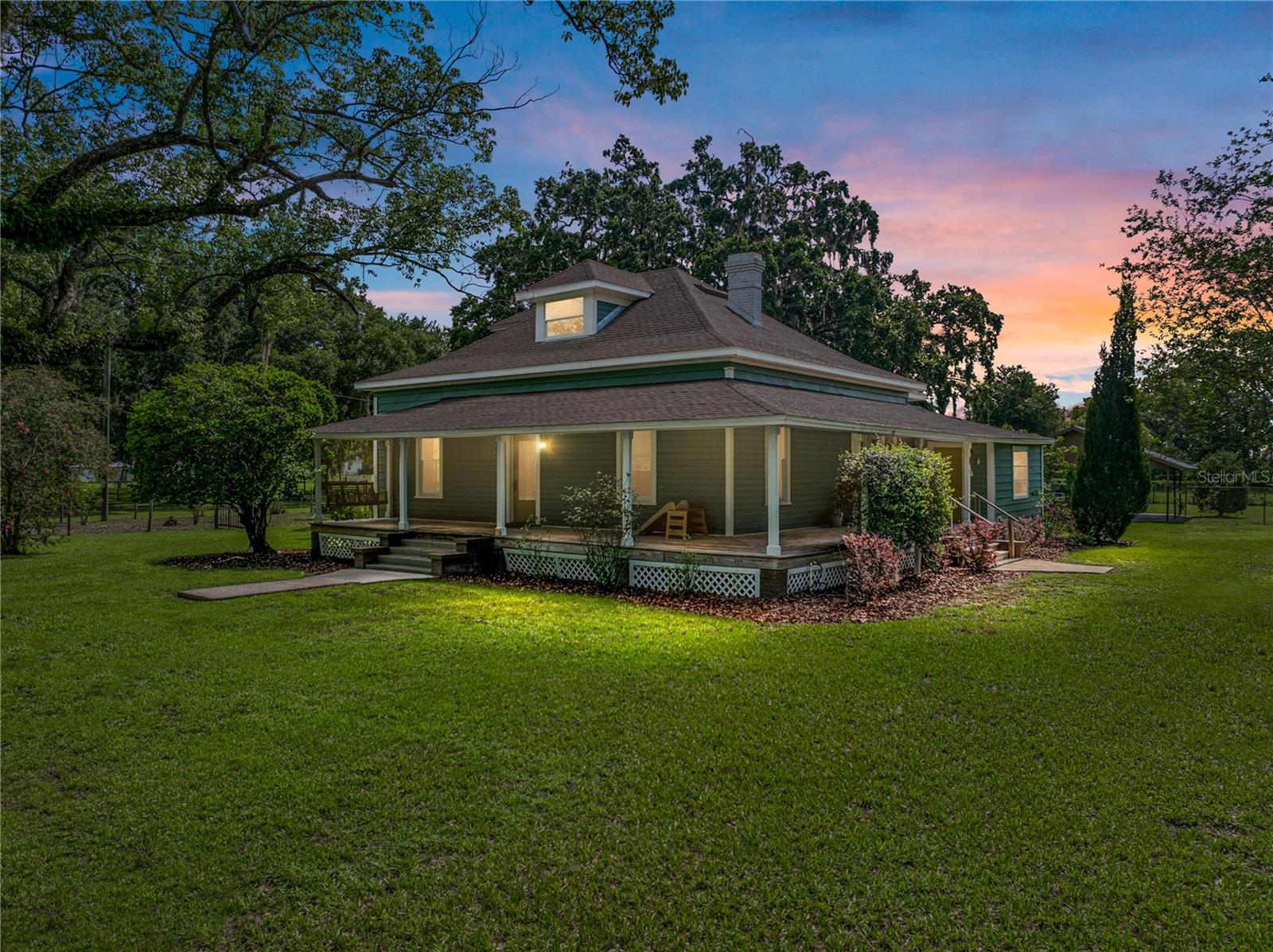 Rare find in North Plant City - Beautifully Updated 4-Bedroom Farmhouse on just under 2 Acres. This charming farmhouse from the 1900’s, originally part of the Wilder family homestead, sits on just under 2 acres of mature oaks and landscaping in a rapidly growing area of North Plant City. The home features 4 bedrooms and 2 1/2 bathrooms, a wraparound porch, and original, recently restored heart pine floors in the bedrooms that add character and warmth throughout. The house has been thoughtfully updated over the years, including a newer roof, two newer HVAC systems, updated electrical and plumbing, brand new floors in the kitchen, hall bathroom and breakfast nook, a fully renovated laundry room, and a brand new water softening system and reverse osmosis filter installed in the kitchen! The property is fully fenced and includes a large custom built chicken coop designed to match the home’s style with its own fenced area for chickens to free range. This property has mature guava, fig, mulberry, pomegranate, elderberry and moringa trees. Also, young mango, peach, macadamia nut, Starfruit, avocado trees, cherry bushes, grapes and many more!! There’s an existing concrete slab with water and electric hookup that offers a great opportunity to build a new outbuilding or garage. Additional features include a large functional garden, fencing, gates and a shed. The home runs on well and septic, has a two-car carport, and benefits from no HOA or CDD fees. Conveniently located with easy access to I-4 and centrally positioned between Tampa and Orlando. This is a unique opportunity to own a historic home with modern updates and plenty of room to enjoy country living right near the city. Come see this unique and magical property in the rapidly growing north plant city area today!