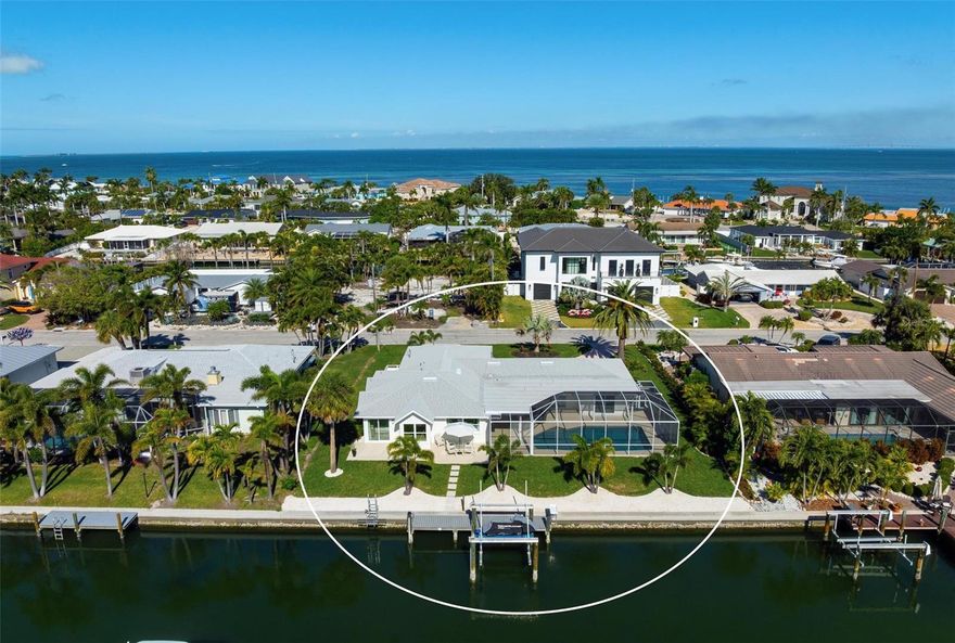 Waterfront Living at Its Finest in Key Royale on Anna Maria Island. Step into effortless luxury with this newly remodeled canal-front retreat, ideally located on an 11,543 sq ft lot in the heart of the coveted Key Royale community. Designed for relaxed coastal living, this beautifully updated 3-bedroom, 3.5-bath home offers the perfect blend of style, comfort, and waterfront lifestyle. The heart of the home is a stunning, chef-inspired kitchen featuring wood cabinetry, sleek quartz countertops, a gas range, wall oven, wet bar with wine refrigerator, and a generous center island — perfectly suited for both everyday living and elegant entertaining. Walls of sliding glass doors bathe the interior in natural light and open to a private outdoor oasis, creating a seamless indoor-outdoor flow. Two of the bedrooms have private ensuite baths, including the primary bedroom which features a spacious bedroom with an en-suite bath with a soaking tub, a walk-in shower and an outdoor shower providing comfort and privacy. Outside, enjoy the resort-style pool (resurfaced in 2020), unwind in the screened lanai, or take in peaceful canal views framed by lush tropical landscaping — all designed for lounging in both sun and shade. A true boater’s dream, the property features a private dock with electric and water, plus a boat lift (installed in 2021), offering quick access to the sparkling waters of Tampa Bay and beyond. Additional updates include a roof installed in 2017 for added peace of mind. Just a short stroll or bike ride from Anna Maria Island’s sugary beaches and moments from charming shops, dining, and island attractions; the location is as exceptional as the home itself. Residents of Key Royale enjoy access to a clubhouse and a 9-hole golf course, creating a lifestyle that perfectly balances boating, golf, and island leisure. Bring your boat, fishing poles, golf cart, and clubs — and start living the island life you’ve been dreaming of. This is a rare opportunity to own a truly special slice of waterfront paradise.
