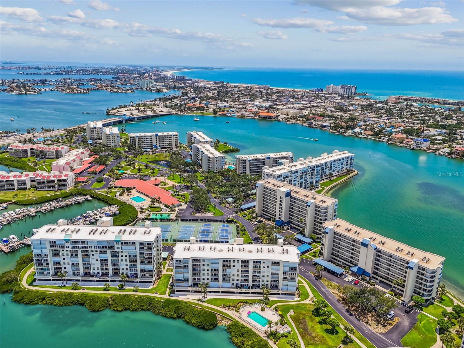 If you have been watching Harbourside, this is the one. Experience resort-style living in the prestigious gated waterfront community of Harbourside. This unit is located in the desirable Sunrise building—just 5 minutes from St. Pete Beach and 15 minutes to downtown St. Pete. Offering EXPANSIVE NORTH-FACING VIEWS OF BOCA CIEGA BAY from an oversized balcony—this location is ideal for enjoying cool sunrises and coastal breezes. Inside, you'll find 2017 IMPACT HURRICANE-RATED SLIDERS AND WINDOWS, a spacious master suite with high ceilings, walk-in closet, and an updated master bath with dressing area, along with a bright kitchen featuring granite countertops, white cabinetry, eat-in space, and a pantry. Major systems include a 2011 A/C, 2014 water heater, and 2024 roof. Additional highlights include in-unit laundry with front-loading washer and dryer, under-building parking, private storage, and pet-friendly policies. Harbourside is known for its solid, well-managed association and exceptional amenities that make it feel like a yacht club-style waterfront resort, including multiple pools, tennis and pickleball courts, shuffleboard, fitness centers, a SCENIC WATERFRONT WALKING TRAIL, marina, clubhouse, and more. Perfect for water lovers and beachgoers, with fast access to shopping, dining, Corey Ave Market, Horan Park, and outdoor recreation. Building has completed Milestone and Reserve Study—Please schedule your appointment to show today. Seller will review all offers by Monday at 3:00pm. Don’t miss this opportunity!