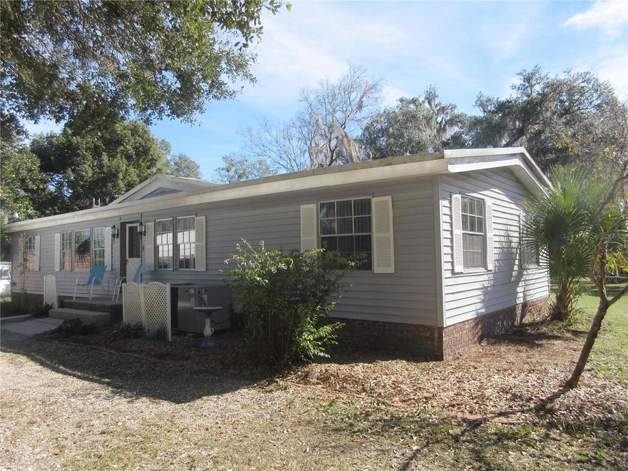 AFFORDABLE WATERFRONT LIVING AT IT'S BEST! Come see this mint condition 1978 1,436 SQ FT 24x60 Fleetwood 3/2 doublewide mobile home sitting on a .64 acre wide canal lot just 100 yards away from 400 acre North Lake with some of the best BIG BASS FISHING, boating, sailing, skiing, jet skiing and kayaking anywhere in the state of Forida! Outside features both a private on-site concrete boatramp plus a separate community twin size boatramp with Marina and clubhouse. The home has a 1997 built up insulated aluminum roof and a 14x27 Florida Room/Screenroom with a 2011 insulated roof on a slab with concrete block knee walls. The Florida room has vinyl windows for year round enjoyment overlooking the Bass filled waterway. The back yard has a lovely black decorative fenced area for your dogs to run with a fabulous circular fire pit to enjoy on those chilly nights to snuggle around. The entire home sits on a concrete block foundation with an attractive real brick front face. In front is a handy 2 car carport and a great 14x16 two story workshop with an attached boat port and an attractive flower trellis. Also inluded is an 8 x 10 shed which includes a riding and push mower. Outside also features a new 2023 central A/C Heatpump, circular driveway, underground electric and a lovely loveseat swing along side the waterway for wildlife watching and to count the Bass jumping! Outfront is another garden sitting bench for bird watching! The home has tinted windows throughout. Inside features a TURN KEY fully furnished home, a huge 18 x 27 great room, a custom horse shoe shaped eat-in kitchen with a full length eat-in bar fully equipped with a range, refrigerator, microwave and a new 2024 dishwasher. The 14 x 18 master bedroom has a make-up desk, walk in closet, built in make up counter, garden tub & shower together with a handy pine sit down cabinet for extra storage and full tub in the guest bath. Also included are slow close high rise cammodes, Closet Maid shelving throught out, a handy storage nook in the laundry room which includes a dryer and a 2024 washer and GFI in both baths. This home has a large pantry, tons of storage, certified survey (see attached in photos) and sits on a quiet breezy dead end cul-de-sac street tucked away in nature. Enough said! Just come and see it for yourself. An absolute GREAT BUY at just $185,000! Hurry and bring your fishing pole, clothes and simply move in! Home is located in the Ocala National Forest which affords you almost a ½ million acres of Forest to roam, 600 lakes, 2 rivers, Juniper Springs, Silver Glen Springs, Salt Springs, Swimming, Skiing, Big BASS Fishing, Boating, Camping, Hiking, Horse back riding and some of the best ATV riding anywhere. Daytona Beach is just 1 hour away. Let the fun begin! You need it!