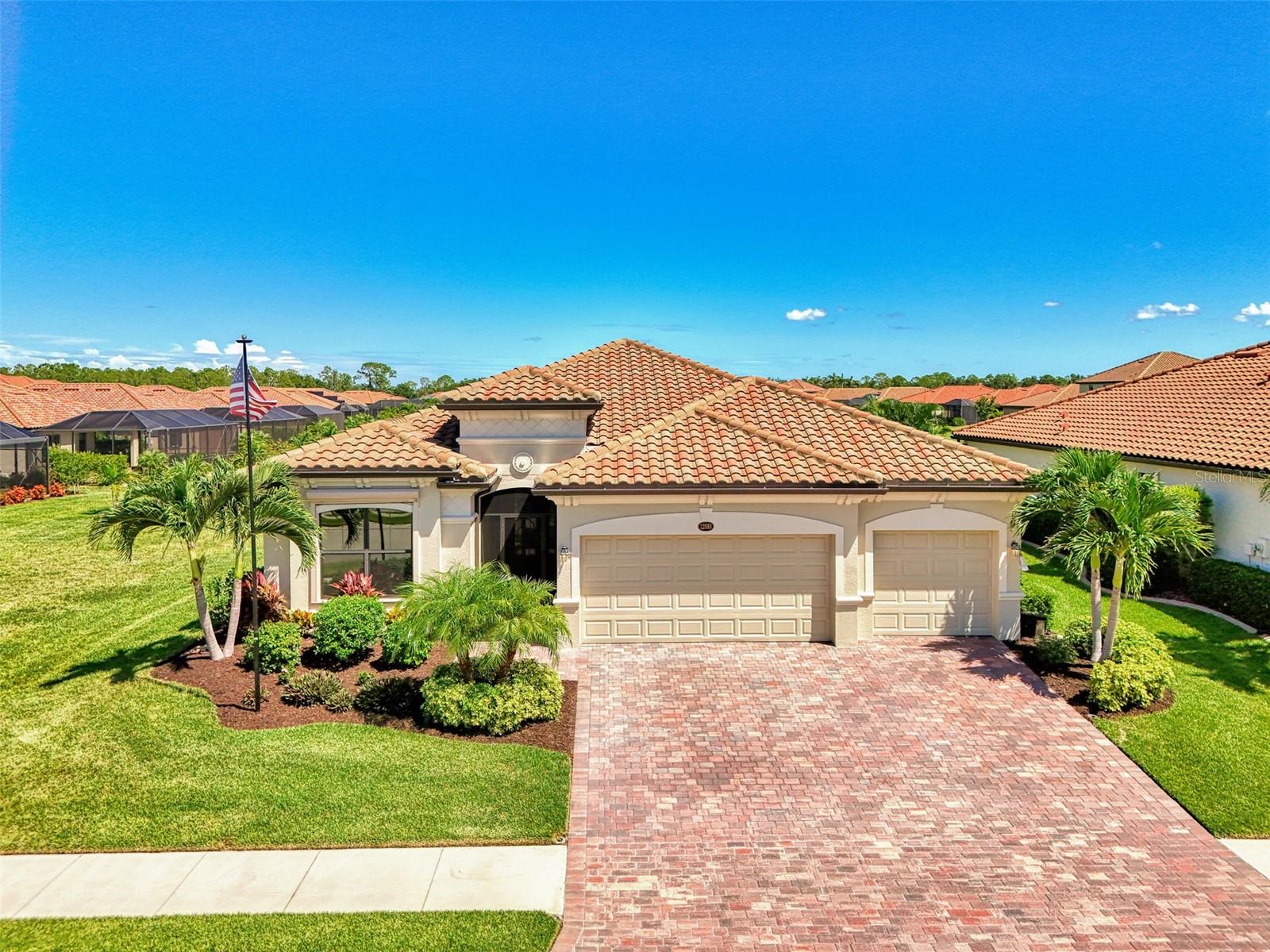 Now is your opportunity to own the LOWEST PRICED 3-CAR GARAGE SINGLE FAMILY HOME available in all of Wellen Park! Located in the guard gated Tuscan Inspired community of Gran Paradiso, this 2020 built Princeton model home boasts 4 bedrooms, 2 bathrooms, a 3-car garage, and over 2200sf of open concept living. Situated without a home to the left, this home enjoys a stunning long lake view that will bring you hours of peace and enjoyment. The owners installed an oversized extended lanai that is complete with upgraded pavers, additional under-cover space with two hard wired ceiling fans, and clear view panoramic screen. There is an automated Storm Smart Hurricane Shutter that rolls down over the lanai to make storm prep a breeze, as well as roll downs on the front and rear windows, accordion shutters on the front door, and easy to install panel sleeves on the sides. There is also a whole house water purification system (2024), whole house gutters, and generator hook-up. Step inside from the screened-in front porch and you will find beautiful crown moldings and tile on the diagonal throughout all of the main living spaces, as well as brand new upgraded luxury vinyl plank flooring in all of the bedrooms, making this home carpet free! The entire home, both inside and out, has been re-painted with upgraded paint. The large living room is perfect for entertaining and enjoys expansive water views, and the kitchen with upgraded tile backsplash was smartly designed with white shaker style cabinets, sparkling granite, and a stainless-steel appliance package. A new single-bowl kitchen sink was installed with a reverse osmosis system that provides the cleanest drinking water, and new under cabinet lighting was also recently added. The primary suite is tucked in the back of the house with views of the lake, and it enjoys a large walk-in closet. The primary en suite with dual sink vanity, and separate water closet for privacy, was just renovated by removing the builder tub and shower to create a custom oversized seamless glass walk-in shower that is sure to impress! Across the house you will find two equally sized bedrooms that are located just off the foyer, and a 4th bedroom located on the opposite side that creates tons of privacy for all. There is a large laundry room with utility sink, and the 3-Car garage has overhead storage that was added, as well as upgraded insulation in both the attic and the garage door to control the temperature. The owners permitted to add city water irrigation that allows either city water (as currently set up), or it can be converted back to HOA reclaimed water at the change of a fitting. SimpliSafe Fire and Security System. Gran Paradiso enjoys 5 STAR AMENITIES, such as a stunning guard gated entrance, a resort style pool and hot tub, impressive clubhouse with library, card and billiard rooms, onsite HOA staff, state of the art fitness center with fitness classes, his and her locker rooms with saunas and steam rooms, tennis courts, pickleball courts, and so much more! Gran Paradiso is golf cart friendly and features fabulous neighborhood events. Located minutes to the new town center of Wellen Park, the CoolToday Park Stadium (home of the Atlanta Braves Spring training camp), historic downtown Venice, and several area beaches, this location is perfect for enjoying everything Venice has to offer! If you have been dreaming of owning your piece of Florida's paradise, then this stunning property at Gran Paradiso is for you!