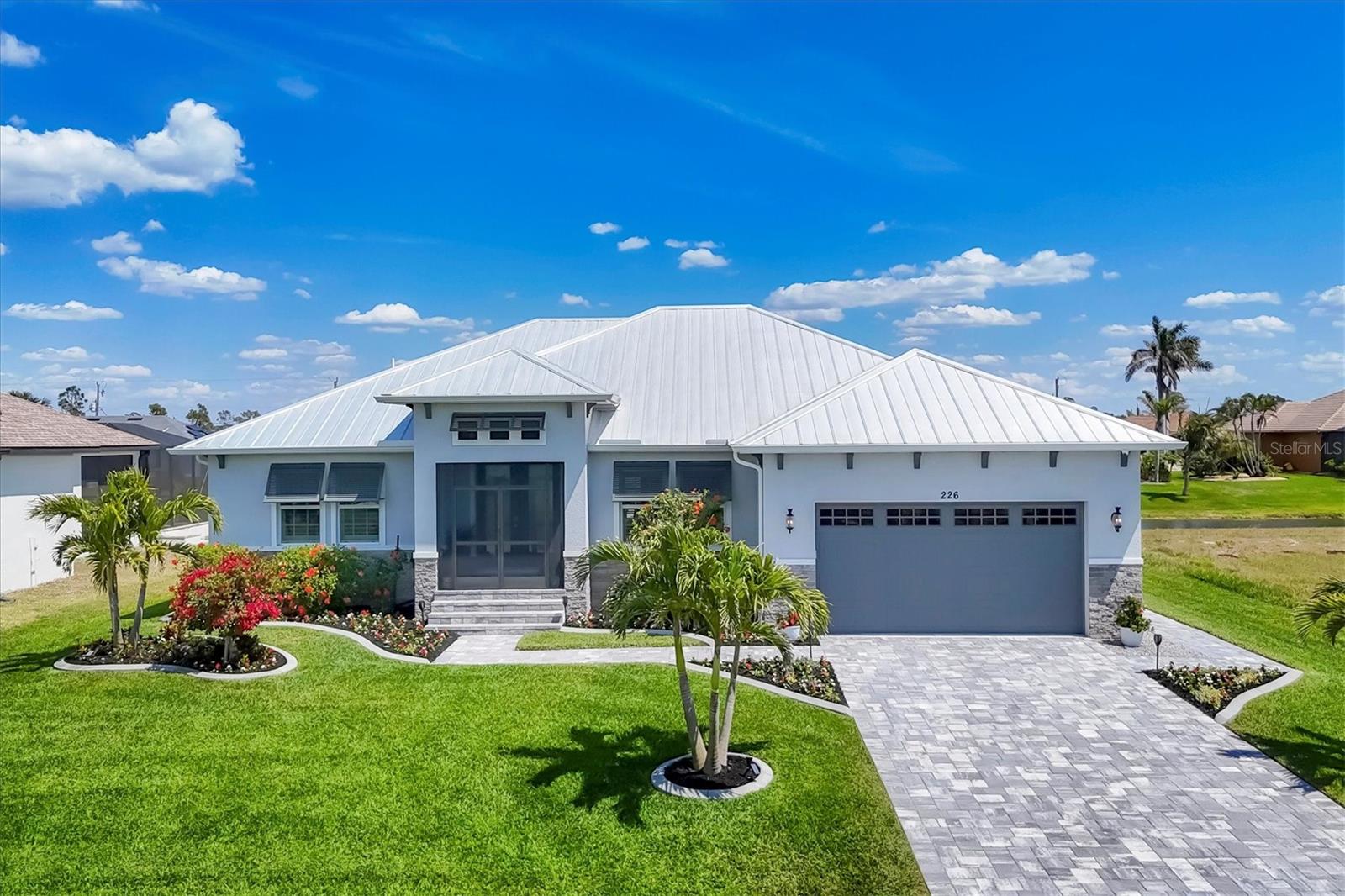 Own Your Own Personal Resort! Experience the ultimate in Florida living in this stunning pool home, elegantly situated just minutes from the beautiful beaches of Boca Grande and Manasota Key. Located between Sarasota and Fort Myers you have all the conveniences we've grown accustomed to and are in very close proximity to Airports, I-75 and gorgeous beaches. Rotonda West is a highly desired community within a short drive to beaches, restaurants and shopping and offers five golf courses located within the community.
Located on a Cul de sac street, this beautifully landscaped property blends sophistication and practicality, boasting a wealth of custom upgrades that elevate everyday living. Every detail has been carefully crafted, including power storm shade and a whole-house generator with underground 250-gallon propane tank. Thoughtfully designed with additional spray foam insulation throughout the home for efficiency, including an insulated garage door keeping the home cool/warm and quiet. With the impact windows, hurricane proof construction and a metal roof, this home is built to last. The oversized two car garage has added metal wall cabinets and there is ample space to add a workbench.
Come inside the screened front porch and through the double rain glass doors to discover the beautiful, coffered ceiling in the living area and trayed ceilings in the primary bedroom, foyer, office and dining rooms. The open layout flows effortlessly into the living and dining areas and the adjacent office could allow for an easy conversion to a fourth bedroom, perfect for guests. Plantation shutters throughout allow for plenty of privacy and the sliding wall of glass doors in the living area and dining areas open to the outdoor play area allowing for total indoor-outdoor living.
The bright gourmet kitchen features GE Profile appliances with a gas range top, an oversized island and ample counter space with an abundance of stylish white and gray cabinetry. The kitchen boasts soft close, slide-out cabinets, undermount and above cabinet lighting and exquisite high-level quartz throughout. There is added storage inside the island and walk in pantry.
Included are 4 exterior security cameras that will allow exterior viewing of the home at any time from any location, an underground 250-gallon propane tank and a whole house generator that can assure your home will stay operational in the event of a power outage. The metal roof completes the “Key West” style of the home.
Outside the home is adorned with Bahama shutters, corbels and beautiful stonework adding to the character of the home. The stunning low maintenance luscious landscaping is bright and colorful. Relax by the oversized heated saltwater pool featuring a tranquil water feature as you unwind on the spacious screened lanai, all while overlooking a tranquil canal. The outdoor sitting area includes a stainless-steel kitchen with gas burners, hot and cold water, large gas grille with hood, a mini fridge and granite countertops. Adjacent to the outdoor kitchen is a covered eating area with a large screen television and a ceiling fan. The sparkling above ground spa provides additional relaxation for up to 6 people. Plenty of room for the chaise lounges and the oversized umbrella in the sitting area. It is an ideal setting for entertaining and relaxing by the fire pit or enjoying the serene Florida lifestyle. Furniture available for Purchase.