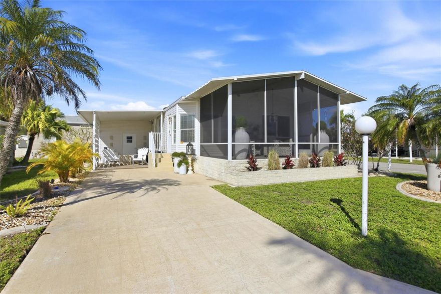 Charming Corner-Lot Home in 55+ Buttonwood Village! Welcome to this well-situated 2-bedroom, 2-bath single-wide home on a desirable corner lot in the active adult community of Buttonwood Village in Punta Gorda. Boasting excellent curb appeal with mature landscaping, this home offers added privacy, an extended driveway, covered patio, and a storage shed—perfect for enjoying the Florida lifestyle. Inside, vaulted ceilings and an open floor plan create a bright, airy space with seamless flow between the living, dining, and kitchen areas. The kitchen features crisp white cabinetry, ample storage, a spacious island with casual seating, and matching white appliances. Wood-look vinyl flooring throughout and warm, earth-toned walls enhance the home’s comfortable, inviting atmosphere. Both bedrooms are generously sized, with the primary suite offering a large walk-in closet. Updated bathrooms feature walk-in showers and modern fixtures. The laundry area, complete with washer and dryer, is conveniently located in a closet off the hallway to the bedrooms. Step out to the front screened-in lanai to relax, entertain, or enjoy a morning coffee with views of the neighborhood and gentle Florida breezes. Set within 54 acres of lush landscaping, Buttonwood Village offers resort-style living with a 4,800 sq ft clubhouse, heated pool, shuffleboard, bocce, horseshoe courts, and fishing lakes—plus lawn care included. Residents enjoy easy access to Charlotte Harbor, waterfront parks, scenic walking trails, and boating or fishing opportunities. Fishermen’s Village, local restaurants, shopping centers, and everyday conveniences are just minutes away, and Punta Gorda Airport is nearby for effortless travel. This corner-lot home combines the tranquility of Buttonwood Village with the vibrant lifestyle and amenities of Punta Gorda, making it ideal for seasonal or full-time living.
**PLEASE ENJOY THE 3D INTERACTIVE VIRTUAL TOUR ASSOCIATED WITH THIS LISTING**