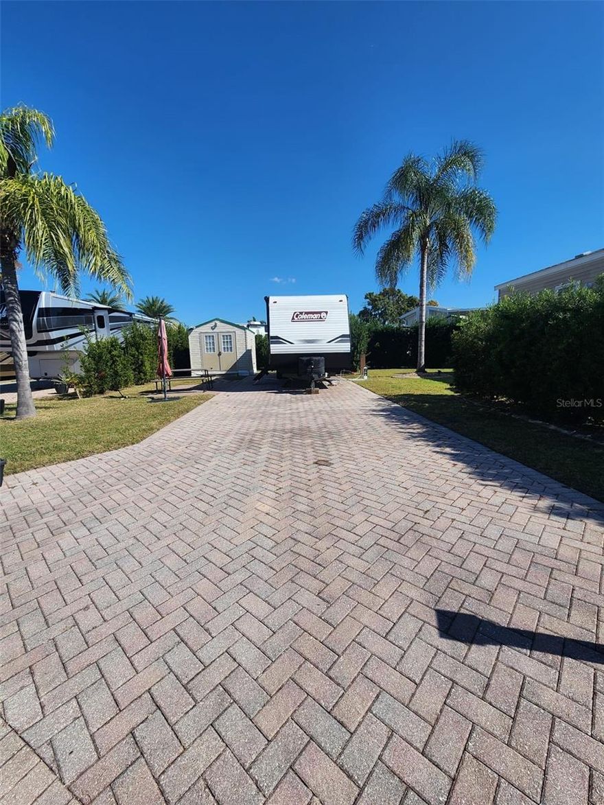 PRICE IMPROVED, This spacious RV lot (#302) is tucked away on a quiet back street in the highly sought-after Elite Resorts at Citrus Valley. The property features expanded paver areas perfect for outdoor dining or entertaining, and a lush wall of privacy shrubs along the side and back that creates a peaceful, secluded atmosphere. A 10' x 12' storage shed is included for added convenience.
There is ample room to customize the space and create your own personal piece of paradise. The association welcomes RVs, sheds, Park Models with porches, and gazebos, offering flexibility for a variety of uses.
Elite Resorts at Citrus Valley is a well-maintained, high-quality community located just 12 miles from Disney and 13 miles from charming downtown Clermont, known for its weekly farmers markets, food truck events, and lively local activities. The resort also offers two bathhouses, laundry facilities, social events, and entertainment.
This property allows short-term rentals, giving you the option to enjoy it part-time and rent it out when you're away — or make it your full-time Florida retreat.