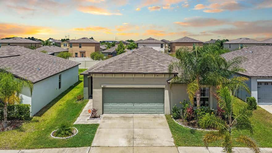 One or more photo(s) has been virtually staged. Welcome home to this beautiful 4-bedroom, 2-bathroom residence, offering the perfect blend of modern Florida charm, effortless maintenance, and ultimate peace of mind. Step inside to an expansive, light-filled open-concept floor plan that seamlessly connects the living spaces for easy entertaining and everyday comfort. Your living experience extends outdoors to a spacious, partially fenced backyard featuring lush, producing mango trees ready for a seasonal harvest, all kept vibrant by an integrated sprinkler system. Designed with convenience and safety at the forefront, this turnkey home comes fully equipped with full hurricane shutters and a premium, upgraded alarm system to give you complete security and confidence year-round. Beyond the property line, the community amenities elevate your lifestyle even further, offering exclusive access to a sparkling community pool, a vibrant playground, and a welcoming clubhouse perfect for gatherings and neighborhood events. Schedule your private tour today and taste the sweet life at King Creek Drive!