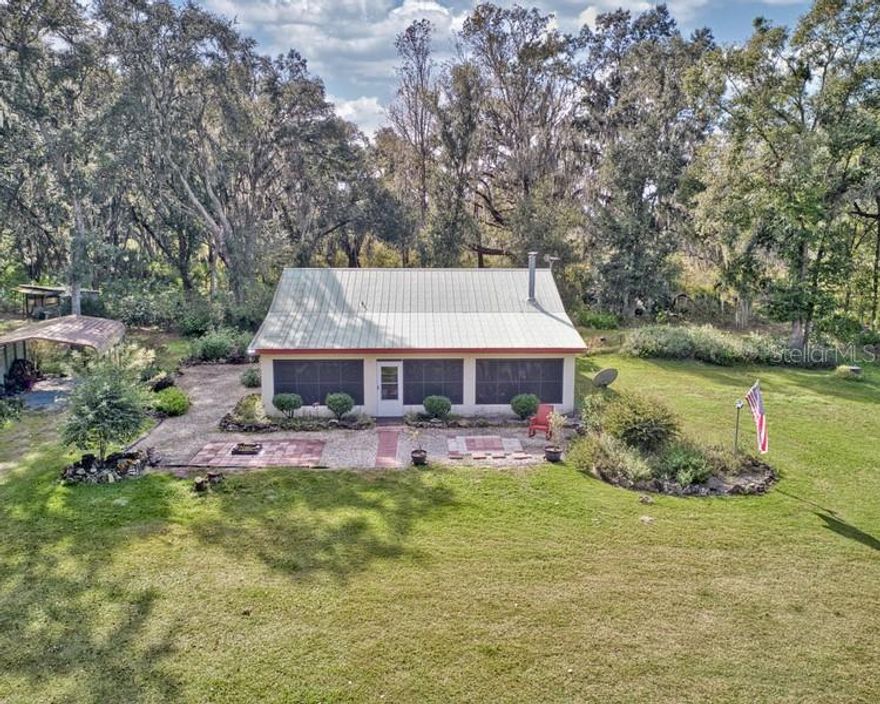 COUNTRY LIVING at its best! 20 ACRES! ONE OWNER, CUSTOM built home with 2 bedrooms, 2 bathrooms and above ground POOL, tucked away from the hustle and bustle, but just a short drive to shopping and dining.  Upon entering the property down the maintained gravel driveway, you will notice a small pond flowing, connecting to the Jumper Creek Canal! Bring all your farm animals to this great parcel, or simply enjoy the peace and serenity! Huge old oaks tower over parts of the property that is fenced and cross fenced into several areas.  Already set up for all your gardening needs with irrigation in place.  FRUIT TREES producing guava, lemon, banana, dragon fruit, starfruit, pomegranate, avocado grapes and more! Several pasture areas for your livestock or pets, plenty of places to add riding rings, etc. if needed! Truly an amazing, level parcel of property with a well maintained home. This home is conveniently close to major highways (SR 50, I75, Florida’s Turnpike, US 301, SR 471) and centrally located for quick access and commute to Tampa, Orlando, The Villages. Call today for a private showing!