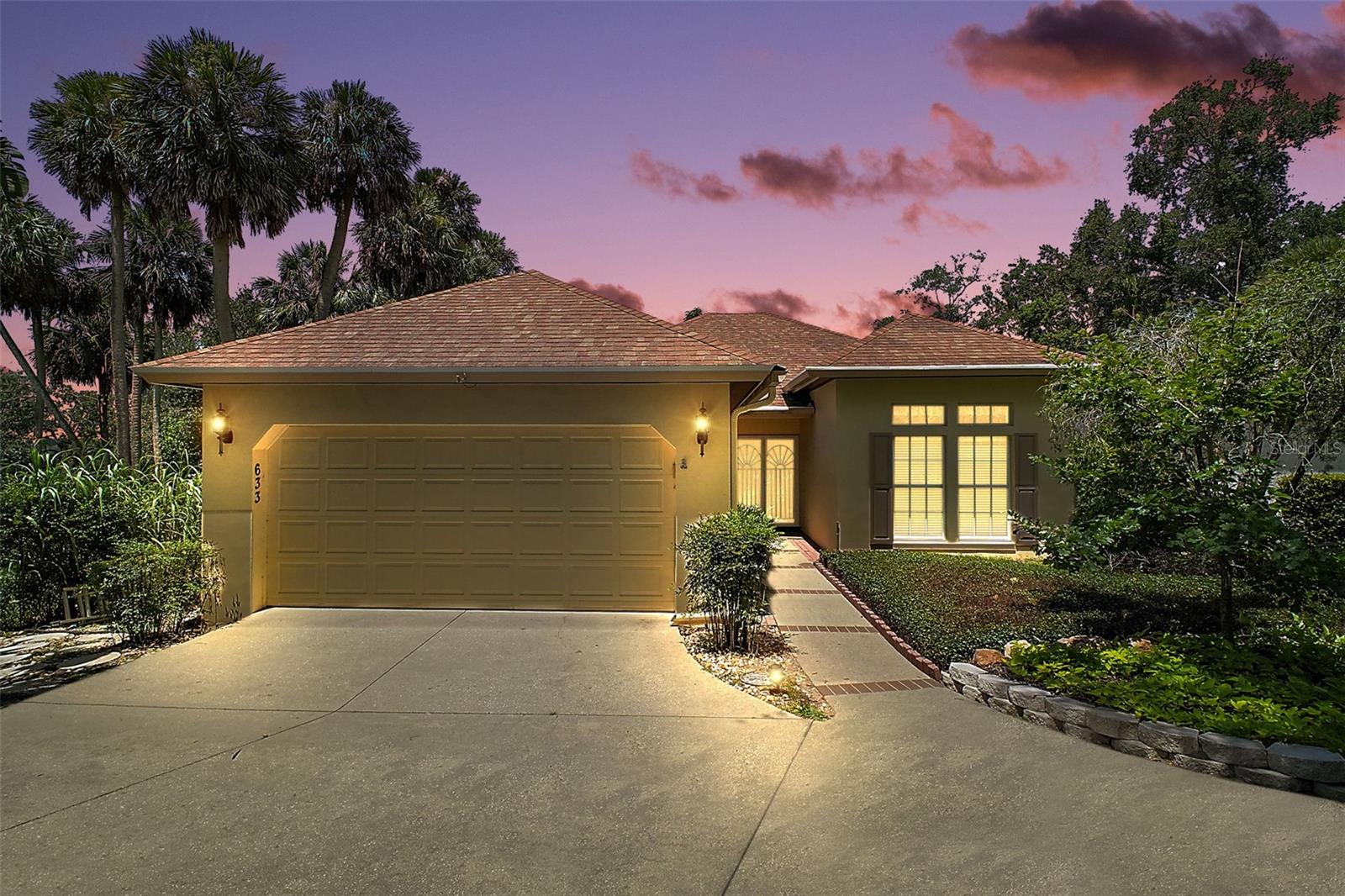 HIGH POINT AT LAKE DORA – A HIDDEN GEM IN DOWNTOWN MOUNT DORA. If you know, you know. If you don’t, you’re about to discover why HIGH POINT is both a best-kept secret and a highly sought-after address in downtown Mount Dora. This exclusive enclave of custom homes sits on a scenic hill shaded by majestic Live Oaks. Adjacent to Palm Island Park and across from Gilbert Park, it offers a rare blend of privacy, natural beauty, and convenience. Residents enjoy exclusive amenities, including a private clubhouse, pool, boardwalk, and dock on Lake Dora with limited boat slips. With parks, trails, a boat ramp, and the nearby marina just steps away, outdoor recreation is always within reach. 633 SANDLAKE COURT – A RARE OPPORTUNITY. It is the first time this thoughtfully designed 3-bedroom, 2-bath custom home has been offered For Sale. Once on site you will discover the benefits of this secluded lot tucked into the corner of a large cul-de-sac and overlooking Lake Dora. Cathedral ceilings in the Great Room and high ceilings throughout the rest of the home offer a sense of expanse overhead while wood floors beneath your feet throughout the main living areas create a warm and inviting atmosphere. The Great Room features tall arched windows and picture-window French doors leading out onto the screened patio with its brick-paved paths, established garden, and Lake Dora sunset views beyond. The generously sized Primary Bedroom features another set of picture-window French doors leading out to the screened patio, a walk-in closet, and ensuite bathroom with dual sinks, a private WC, and a large walk-in shower. The convenient split floor plan has the 2nd & 3rd bedrooms with their shared bathroom up front. You will appreciate the added privacy of pocket doors at strategic locations throughout the home. The kitchen has room for a breakfast table overlooking the adjacent vacant acreage sloping down to Lake Dora where you can view natural Florida at its finest. Neighbors have reported sightings of wild turkeys, foxes, and myriads of aquatic birds and songbirds who make their habitat in the surrounding woods and lush natural groundcover. The mud room conveniently situated between the kitchen and garage features a built-in closet pantry and desk. While the laundry space is currently designated to the garage, it would be relatively easy to renovate and make an indoor laundry room should you desire. THE BEST OF MOUNT DORA AT YOUR DOORSTEP. Less than a mile from downtown, this home offers an unmatched lifestyle. Take a leisurely stroll to explore Mount Dora’s quaint shops, award-winning restaurants, and top-rated arts festivals—without worrying about parking. At day’s end, invite a neighbor to enjoy the sunset views from your private screen-enclosed patio or stroll down to the community’s private Lake Dora dock for sunset views where the sky meets the water creating an expanse of color. At High Point, neighbors aren’t just friendly—they become lifelong friends. Don’t let this rare opportunity pass you by. Schedule your showing today! WHEN VIEWING THE WEBSITE BE SURE TO TOGGLE THROUGH THE MULTIPLE VIDEOS AND 3D TOURS PROVIDED THERE