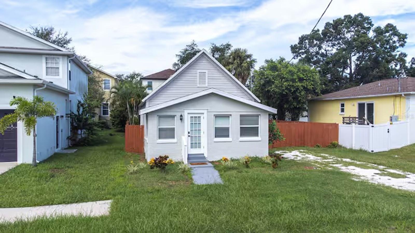 Enveloped in the historic beauty of Port Tampa, this meticulously renovated 1940s bungalow encapsulates a perfect blend of the past and present. It offers three well-appointed bedrooms and two modern bathrooms across an expanse of 1,160 sq ft. As you step inside, the open concept living area welcomes you with high ceilings and an abundance of natural light. The kitchen is a chef's delight, fitted with sleek stainless-steel appliances, under-cabinet lighting, and innovative raised outlets. A sliding barn door opens to a flexible space that can serve as a home office or an extra bedroom. The home extends outdoors into a private, fenced backyard adorned with lush landscaping, a chic paver patio, and a cozy firepit- perfect for intimate alfresco dining or entertaining evenings. Modern amenities such as the new LVP flooring, upgraded electric and plumbing, and an efficient HVAC system complement the aesthetics of the home. It is also freshly painted and meticulously kept dry and clean after storms. This magnificent gem of a home is being offered FULLY FURNISHED with a minimum lease period of six months. The home's prime location near Picnic Island Park/Beach, walking trails, parks, popular shops, highly rated schools, and MacDill AFB. Contact us right away to find out more about this stunning home.