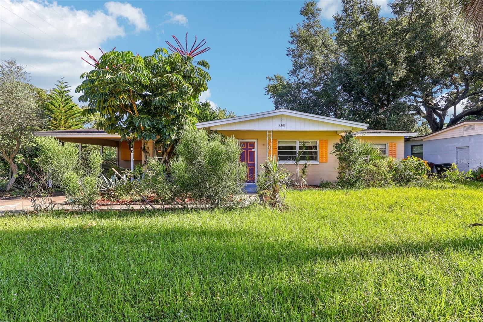 Welcome to 5301 Forzley Street, a charming mid-century block home situated on a generous corner lot in the desirable Queen Acres neighborhood of Orlando. This 3-bedroom, 2-bathroom residence offers 1,104 square feet of well-designed living space on a sprawling 9,358 sq ft lot with no HOA. Perfect for first-time buyers, investors, or those looking to downsize without sacrificing outdoor space, this home offers incredible potential inside and out. Step inside to a light-filled layout featuring original hardwood floors, solid wood cabinetry, and a timeless floor plan ideal for both everyday living and future customization. While the spacious fenced backyard invites outdoor gatherings, expansion, or even a pool addition. The screened-in patio and carport add both comfort and functionality. Centrally located near the Hourglass District, Downtown Orlando, Conway, and major highways, this home provides easy access to shopping, dining, parks, and top-rated schools. Whether you're seeking a move-in ready home with vintage charm or a smart investment with room to grow, 5301 Forzley Street delivers character, convenience, and long-term value in one of Orlando’s most established communities. Don’t miss your opportunity to own this well-maintained gem with endless potential.