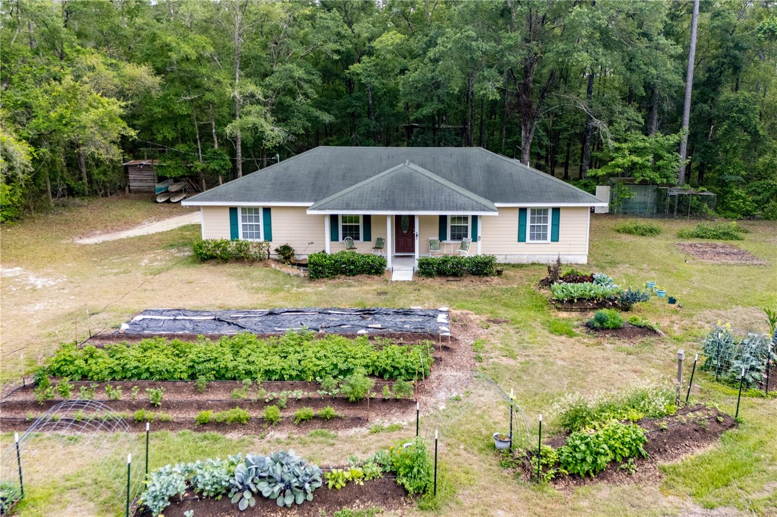 Sitting back on the quiet west side of Union County, this 4-bedroom, 2-bath home at 5876 SW 52nd Terrace is the kind of place where you can truly relax and feel at home. With just over 5.5 acres to call your own—part of it cleared and ready for gardening, play, or animals, and the rest left wooded for peace and privacy—you’ve got plenty of room to stretch out and enjoy the good life. The home sits off a paved country road, and there’s even a sweet little garden out front that adds to the charm. Whether you’re sipping sweet tea on the porch, listening to the birds, or walking the land, this place just feels right. And even though it’s tucked away, you’re only a few minutes from I-75, so running errands or heading into town is no trouble at all.