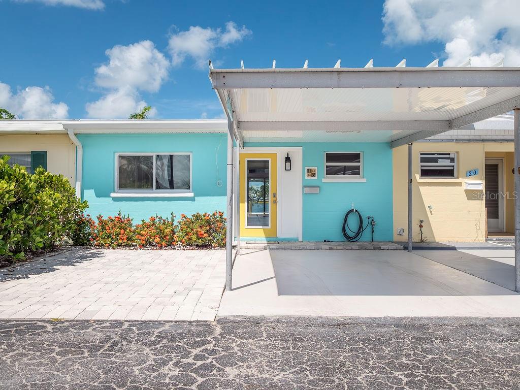 Welcome to this charming 2 bed and 2.5 bath concrete villa located in the heart of Holmes Beach. Offered fully renovated top to bottom this villa has a bright open floor plan and tranquil water views. Features include new bright kitchen with quartz counters, gorgeous baths, luxury vinyl plank throughout, impact windows and doors, new AC, plumbing, electric, roof, and more!
Enjoy the island lifestyle under the oversized covered patio on a sunset facing canal that opens to Watson’s Bayou and the Intracoastal Waterway. New dock, two parking spaces with one car carport and storage shed, too. Historic Seaside Gardens offers a great location with NO HOA. Civic association maintains common areas. Boat ramp, tennis, shuffleboard, pickle ball and the dog park are just steps away. Weekly rentals are permitted, too! This is the perfect slice of paradise!