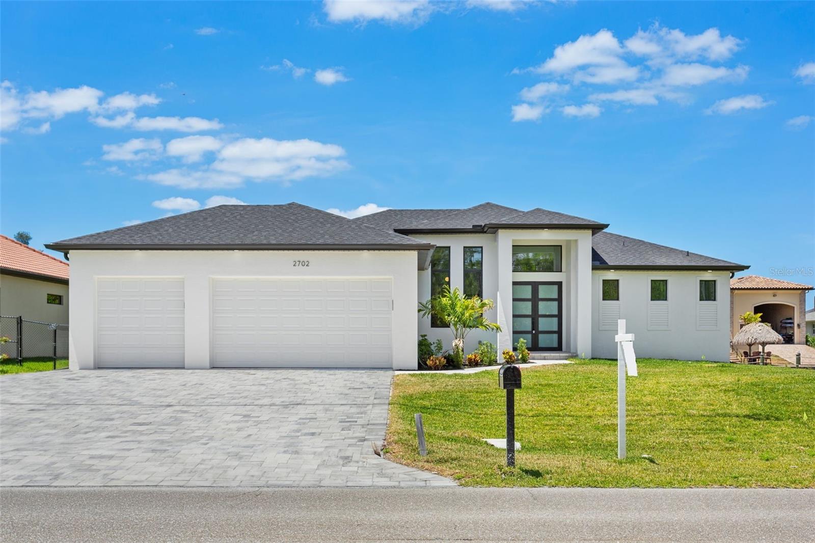 DIRECT GULF ACCESS WATERFRONT CONTEMPORARY HOME in TAURUS CANAL w/ 4-bed, 3-bath, Jacuzzi Spa & Pool & 3-Car Garage! A RETREAT for BOATING ENTHUSIASTS & ANYONE WHO CHERISHES SWFL PARADISE LIFESTYLE! PRIME LOCATION near future SEVEN ISLANDS WATERFRONT COMMUNITY, featuring planned marinas, parks, dining & resort-style amenities! INCREDIBLE POTENTIAL & RISING VALUES make this a SMART EARLY INVESTMENT OPPORTUNITY! *ADJACENT LAND is also FOR SALE, making this A TRULY UNIQUE OPPORTUNITY to EXPAND or CUSTOMIZE! This HOME offers DIRECT ACCESS to GULF, 8-10 miles away. Located on TAURUS CANAL, it provides Gulf access through LAMARK CANAL into LAGUNA LAKE and then into NORTH SPREAD WATERWAY – NO BRIDGES! From here, you’ll have access to Matlacha Pass, Charlotte Harbor north & San Carlos Bay south. Whether you're cruising, fishing, or simply enjoying views, this home’s WATERFRONT SETTINGIS GREAT for those WHO LOVE WATER! Property features 125 ft SEAWALL & PLENTY OF SPACE FOR YOU TO DESIGN CAPTAIN'S WALK, BOAT LIFT, KAYAK LAUCH & TIKI-HUT LAYOUT! This BEAUTIFUL HOME not only caters to WATER ACTIVITIES but also SPACIOUS OUTDOOR ENTERTAINMENT AREA, SCREENED, for RELAXING & HOSTING GATHERINGS. Bright w/ open floor plan, allowing NATURAL LIGHT TO FILL SPACE & highlight its MODERN DESIGN! WESTERN REAR EXPOSURE offers BREATHTAKING SUNSETS & ample natural light, while you enjoy VIEWS OF POOL, SPA, & SALTWATER WATERFRONT, making it ideal spot for relaxing, swimming, fishing, or enjoying outdoor meals on the lanai! EXPANSIVE LIVING ROOM features 14-foot cove ceiling & offers views of LANAI & SALTWATER CANAL! Interior details are designed for COMFORT & STYLE, including TILE FLOORING THROUGHOUT & impact-resistant doors & windows for added peace of mind. MODERN KITCHEN w/ SS appliances, including refrigerator/freezer, microwave, range & dishwasher. It features BLACK AND WHITE ITALIAN CABINETS & spacious QUARTZ WATERFALL ISLAND w/ BREAKSFAST BAR. Primary suite offers plenty SPACE, including PRIVATE SLIDING DOORS TO LANAI & LARGE walk-in closets w/ wood shelving & hangers. Primary SPA BATHROOM features separate tub & shower, dual sinks & quartz countertops - the spot to unwind & relax after a day boating! SPLIT FLOOR PLAN provides privacy for both residents & guests. 3 GUEST BEDROOMS are perfect for hosting family or friends. One is located at rear of the home, next to POOL BATHROOM, while the other two are at front, sharing a bathroom in hallway between them. Step outside & enjoy SWFL weather in your own backyard paradise! Jacuzzi spa & pool are perfect for RELAXATION & RECREATION. Laundry room is located as you walk into from garage & includes washer & dryer hook up & utility sink. Spacious 3-CAR GARAGE provides plenty of room for vehicles, storage & hobbies, offering both CONVENIENCE & VERSATILITY. Come explore this beautifully designed home w/ DIRECT GULF ACCESS & AMPLE OUTDOOR ENTERTAINMENT SPACE offering the ideal mix of style, convenience & location!
