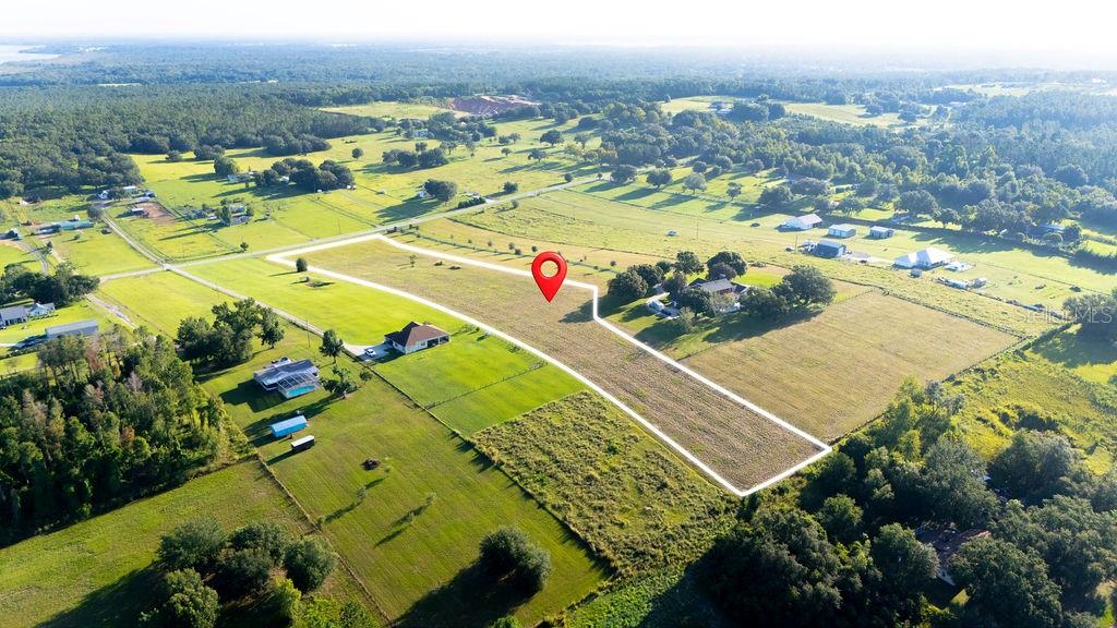 Do you dream to live in a rural area, but close to all shopping, dining, school, restaurants, hospitals and highways?
Discover a rare opportunity to own nearly 5 acres on the scenic slopes of Sugarloaf Mountain, one of Florida’s most beautiful and sought-after locations. This expansive piece of property offers endless possibilities to design and build the home you’ve always envisioned, surrounded by breathtaking panoramic views and the natural beauty of rolling hills. This parcel boasts a brand-new well system, providing essential utilities for your future residence. Enjoy the peace and privacy of your own piece of paradise while still being just a short drive to charming local shops, dining, and convenient access to the Turnpike for easy commuting. Whether you dream of a luxurious estate, a peaceful retreat, or a custom-designed masterpiece, this property offers the perfect canvas for your vision.
Rising as the highest point in peninsular Florida, Sugarloaf Mountain is near the heart of Clermont and all the growth of Minneola. Historically known for its citrus groves, the area has seen significant development. Major national builders like Lennar, Pulte, and Tri Pointe Homes are building numerous new communities, including Lookout Ridge, Sugarloaf Ridge, Pine Ridge, and the 55+ community Del Webb Minneola, all offering a mix of single-family homes, townhomes, and luxury estates.
The development is not just limited to housing. It is supported by a significant expansion of infrastructure, including the widening and extension of roads like Hancock Road and the ongoing Wellness Way Corridor project, which is designed to improve connectivity to major areas like Winter Garden and the Disney resort area. Along with the residential boom, there is building underway for new commercial centers, including the Crooked Can and and the Minneola City Center. This development includes a new school, hospital, fire station, and a variety of retail and dining options. This intense development has given the area the nickname "Millionaires Ridge" due to the high concentration of new, multi-million dollar homes and estates, attracting affluent families seeking a blend of natural beauty, privacy, and luxury living.
